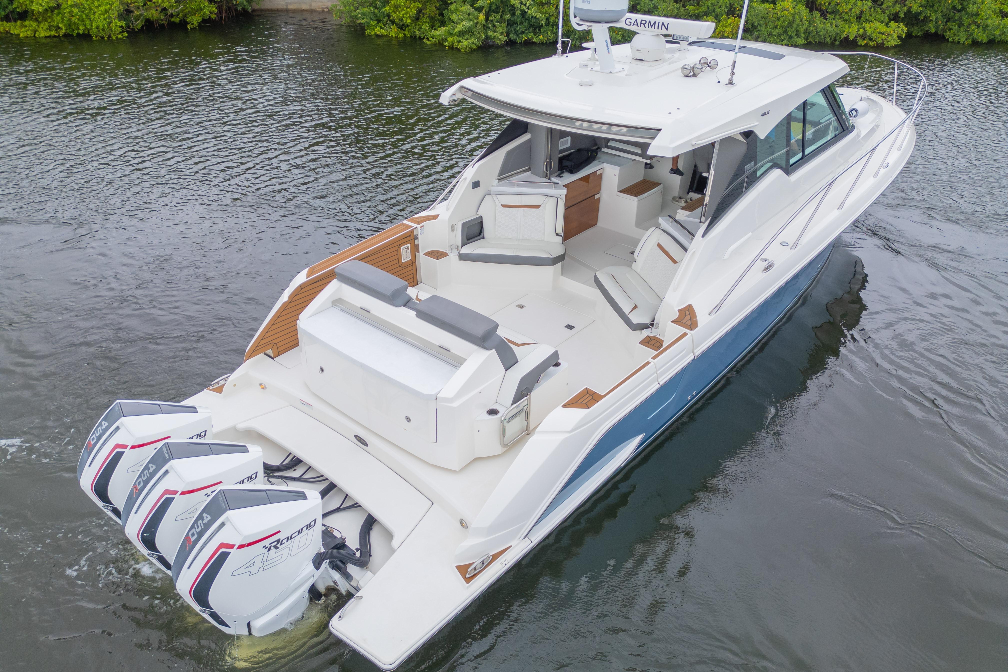 2021 Tiara Sport 43 LE luxury boat with triple outboard engines on calm water.
