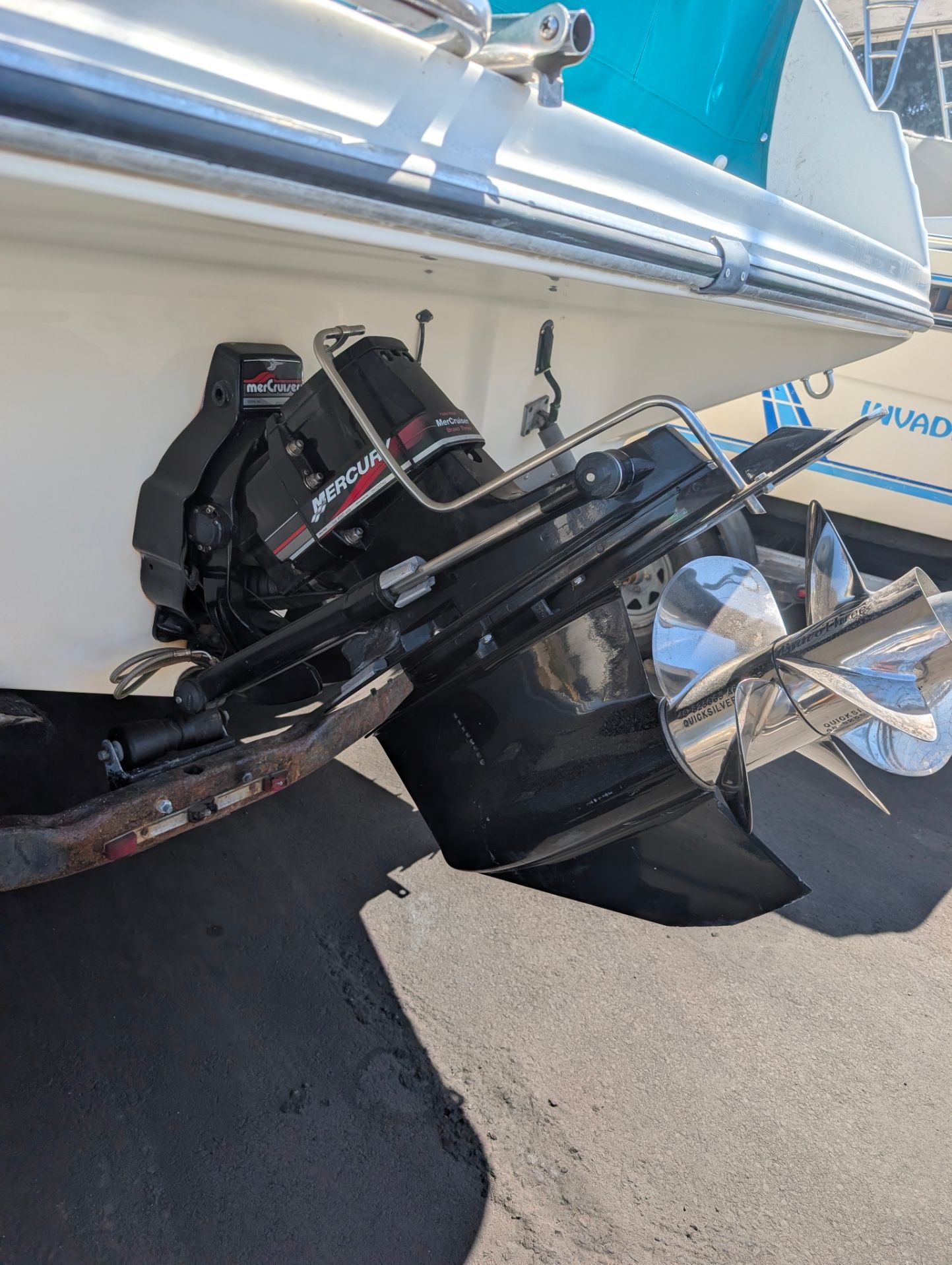 Close-up of a boat engine with a shiny propeller.