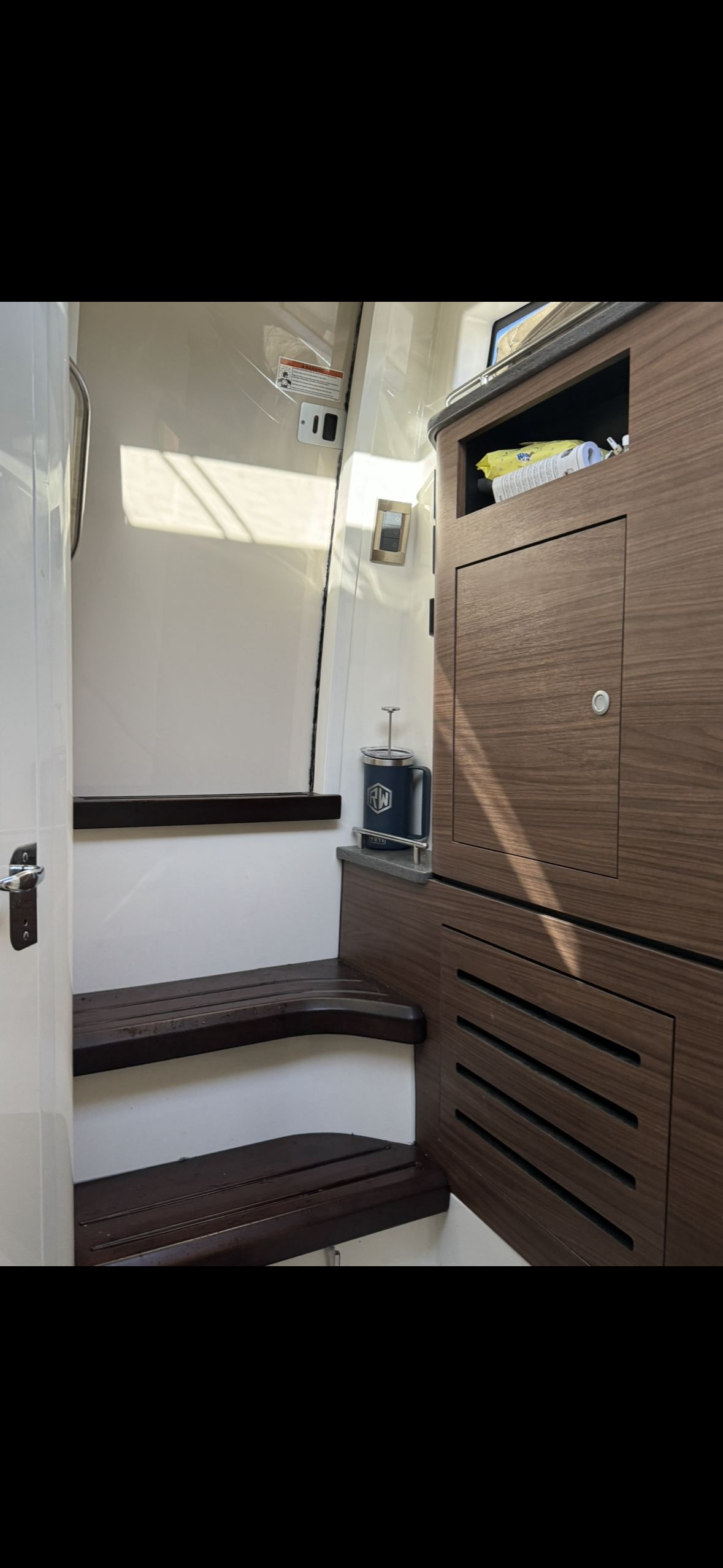 Interior of 2020 Boston Whaler 350 Realm with wooden steps.