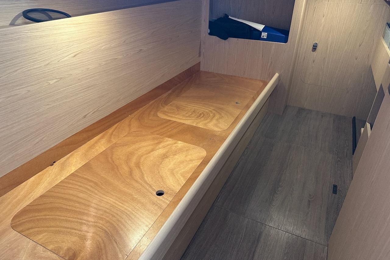 Interior of 2024 Beneteau Swift Trawler 41 Sedan, featuring sleek wooden finishes and storage space.