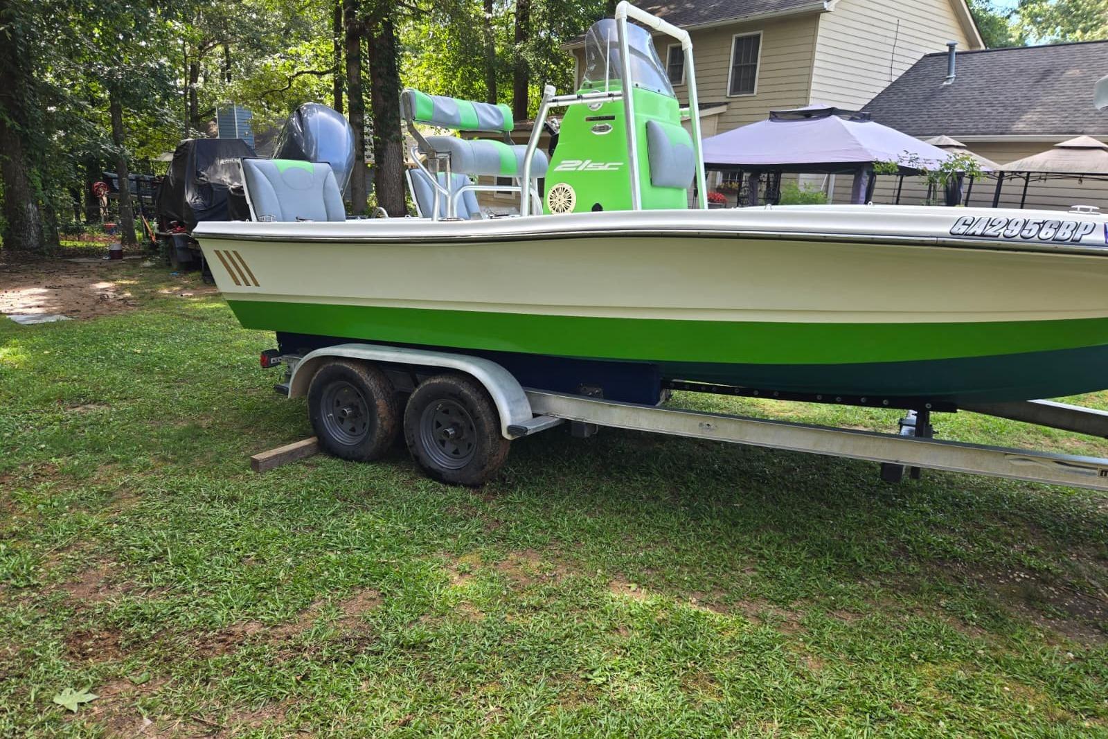 2016 Epic 21 Sport Console boat on trailer in grassy yard.