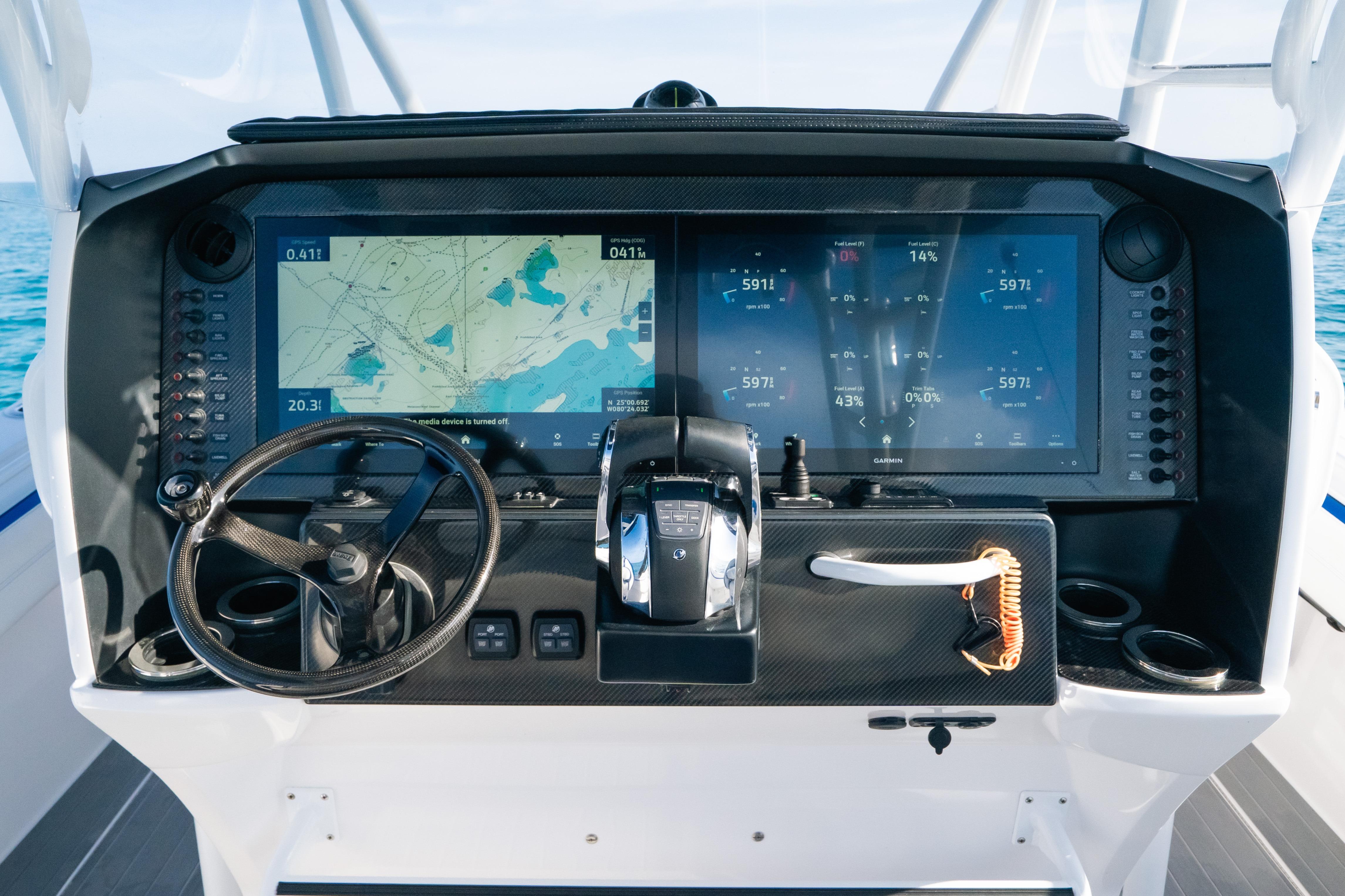 Helm of 2022 Nor-Tech 392 Super Fish with advanced navigation displays and controls.