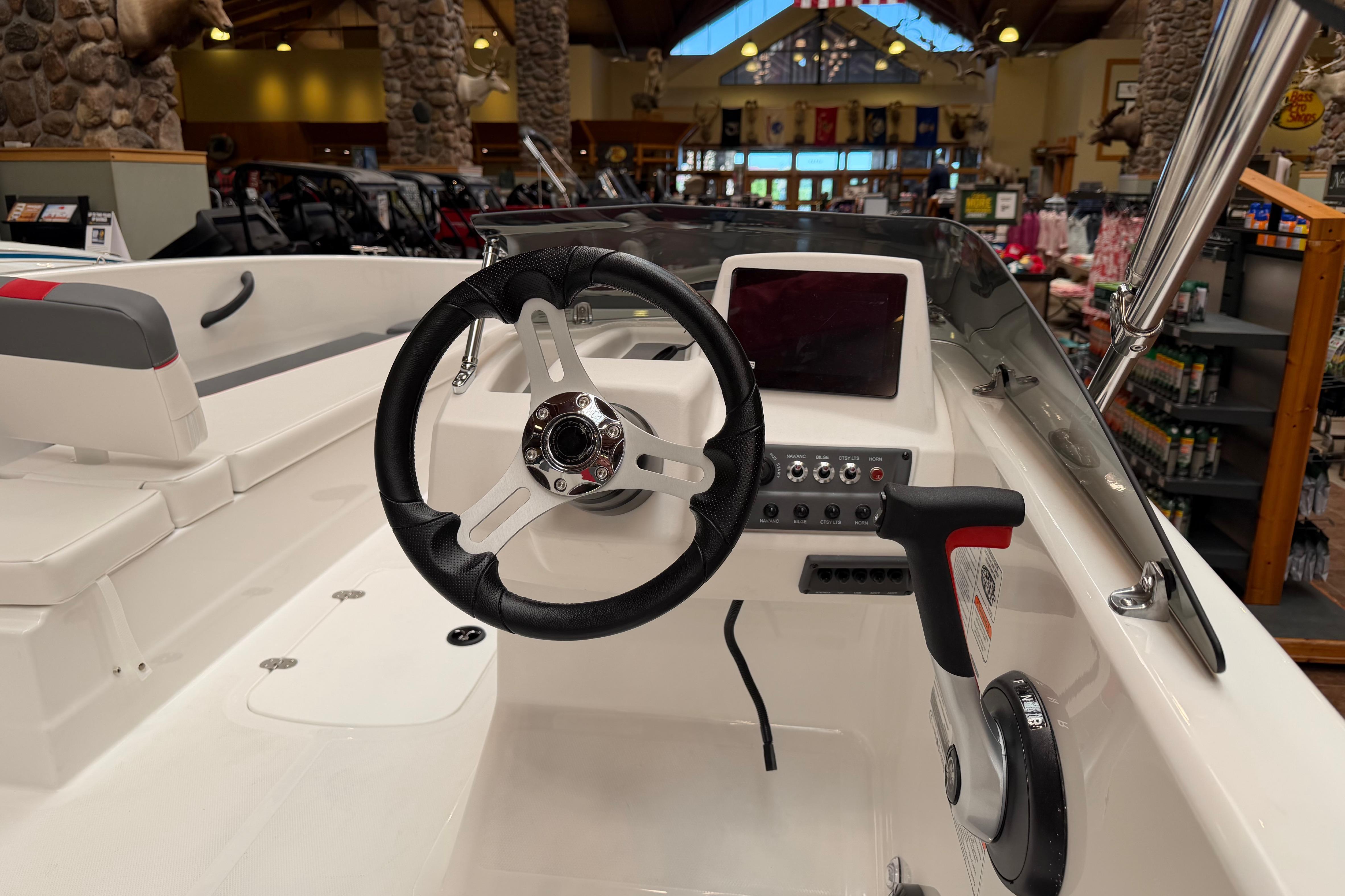 Interior view of 2026 Tahoe T18 boat, featuring steering wheel and control panel.