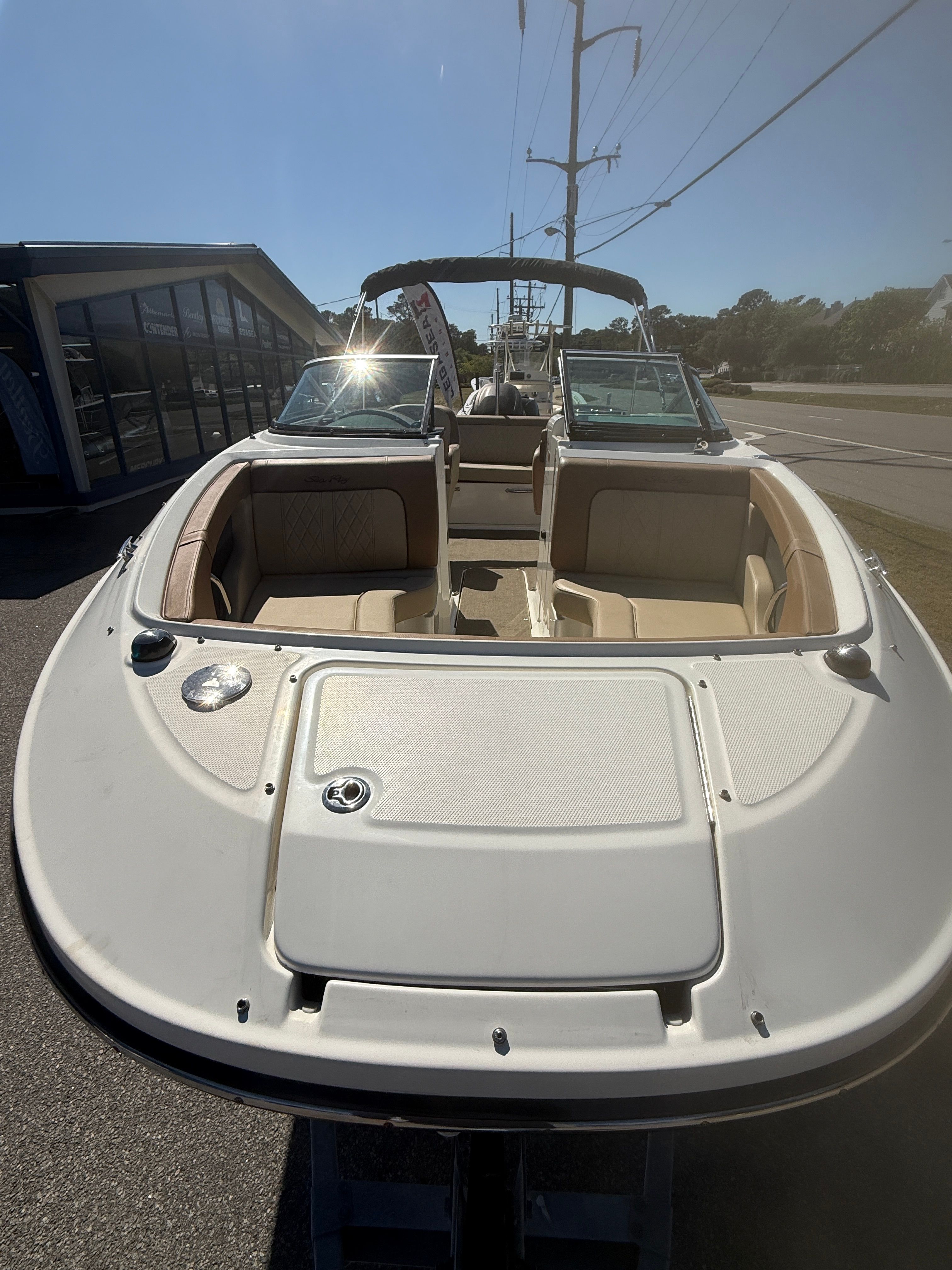 2015 Sea Ray 220 Sundeck OB boat on a parking lot.