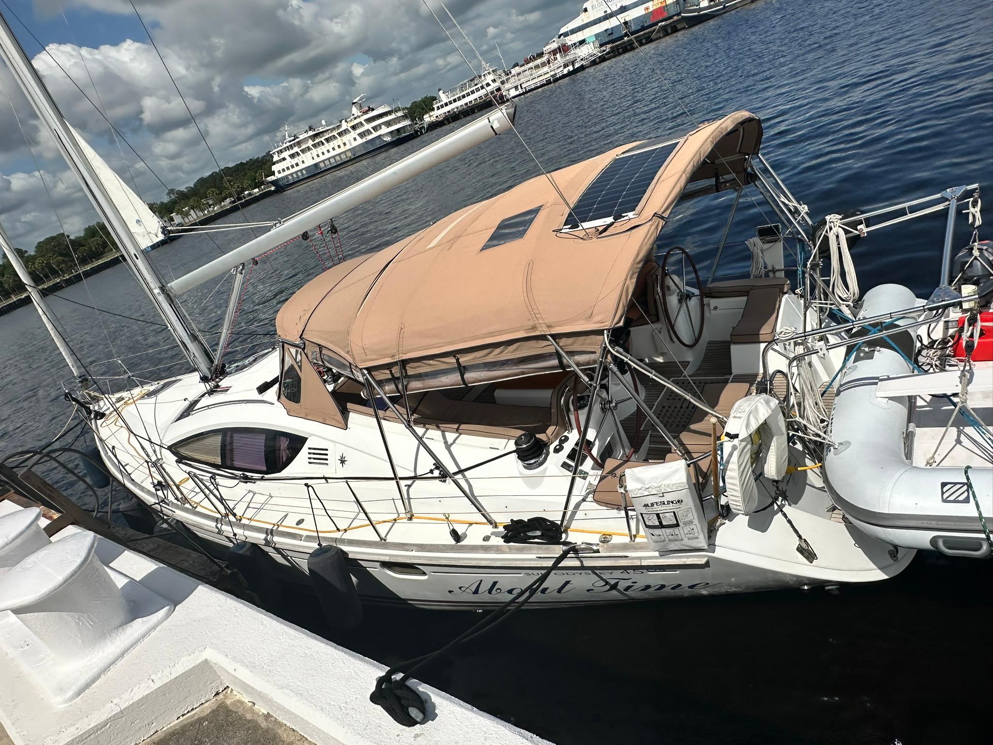 2011 Jeanneau Sun Odyssey 45 DS sailboat docked at a marina under a sunny sky.