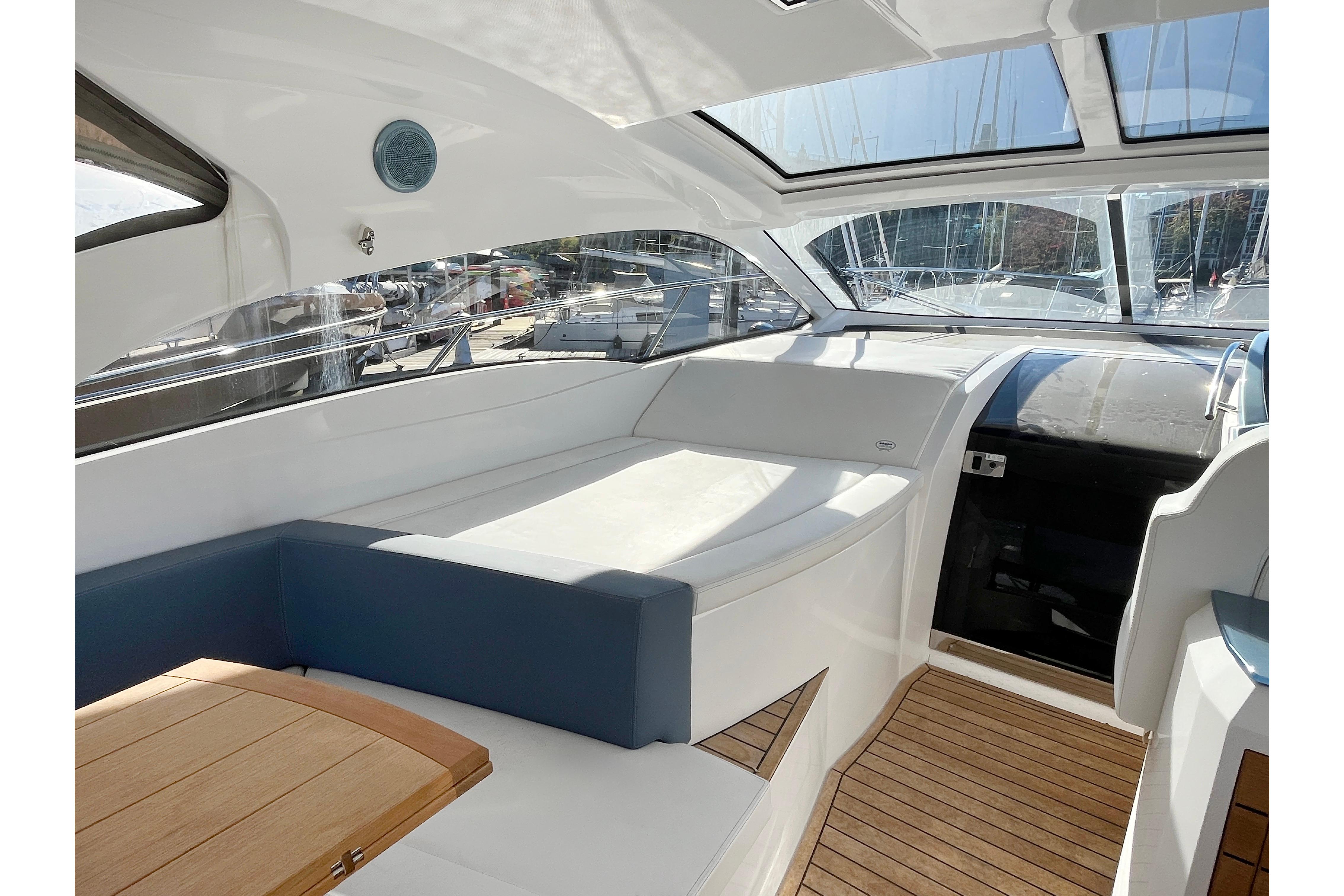 2024 Sessa Marine C38 yacht interior with sleek design and wooden flooring.