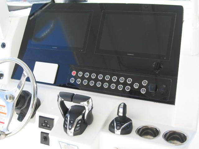 2024 Edgewater 325 CC helm with dual Garmin displays and advanced controls.
