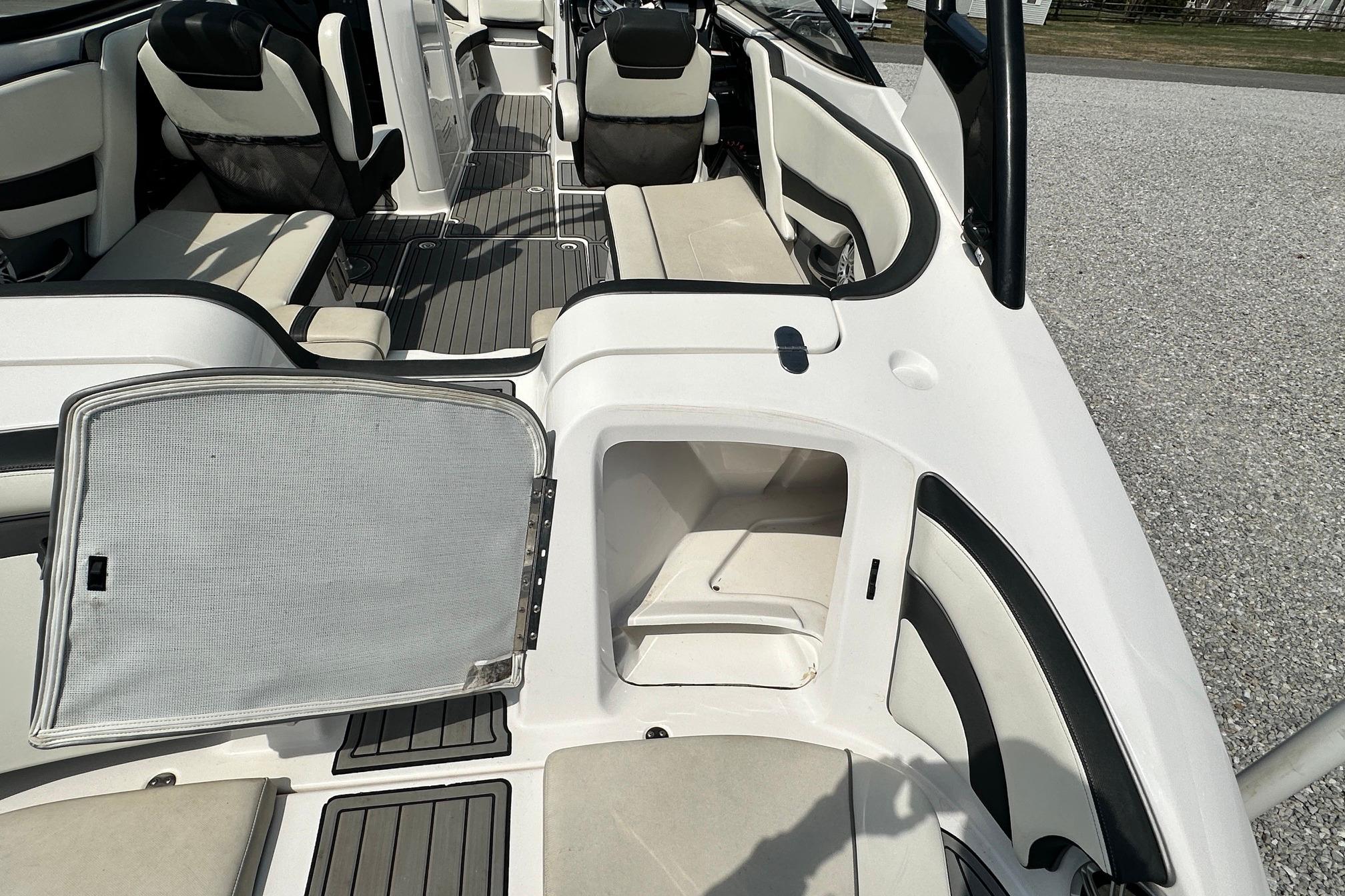 2016 Yamaha 242 Limited S boat interior with open storage compartment.