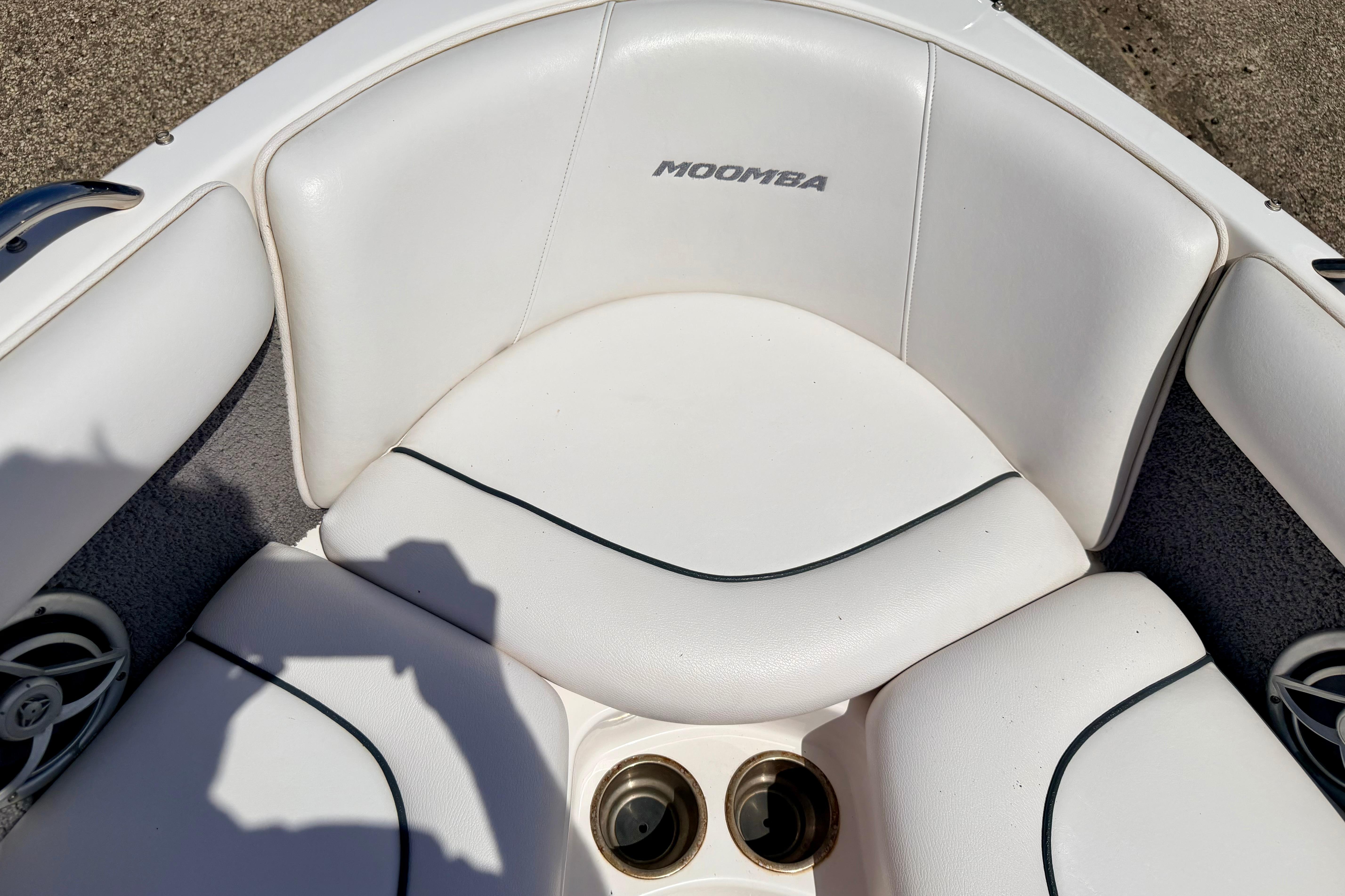 2008 Moomba Outback V boat interior with white seating and cup holders.