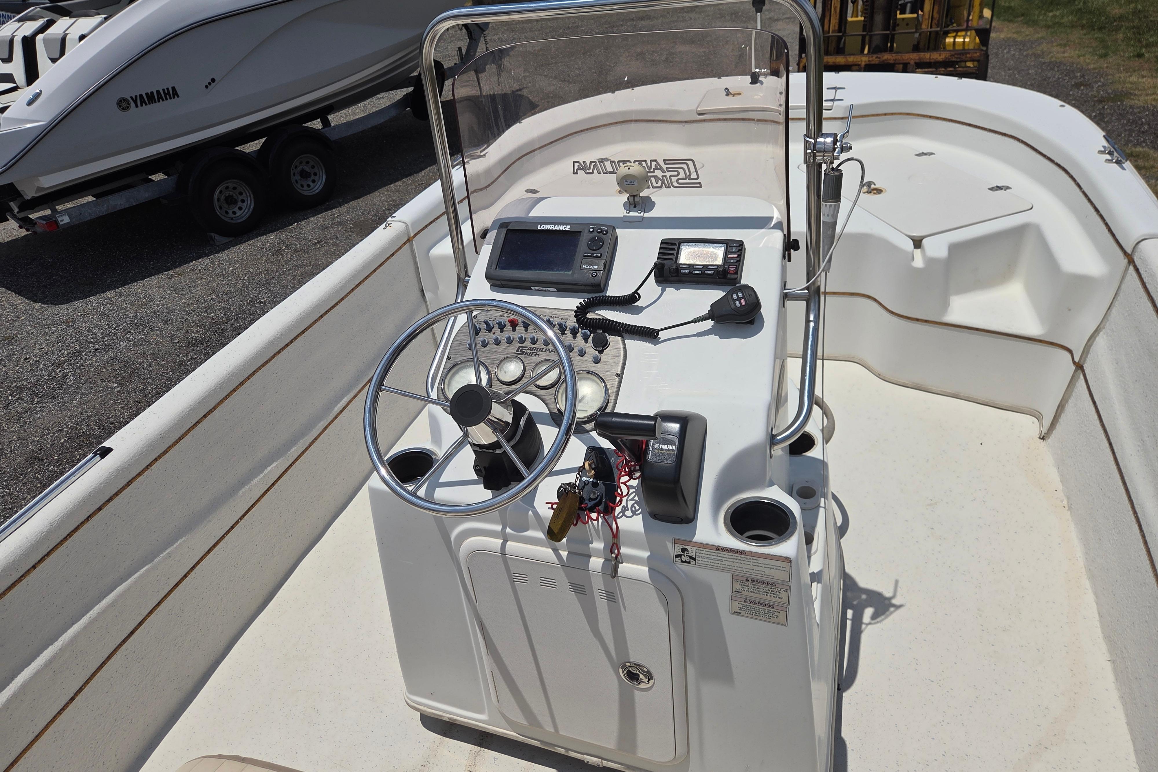 2016 Carolina Skiff 198 DLV boat console with steering wheel and navigation equipment.