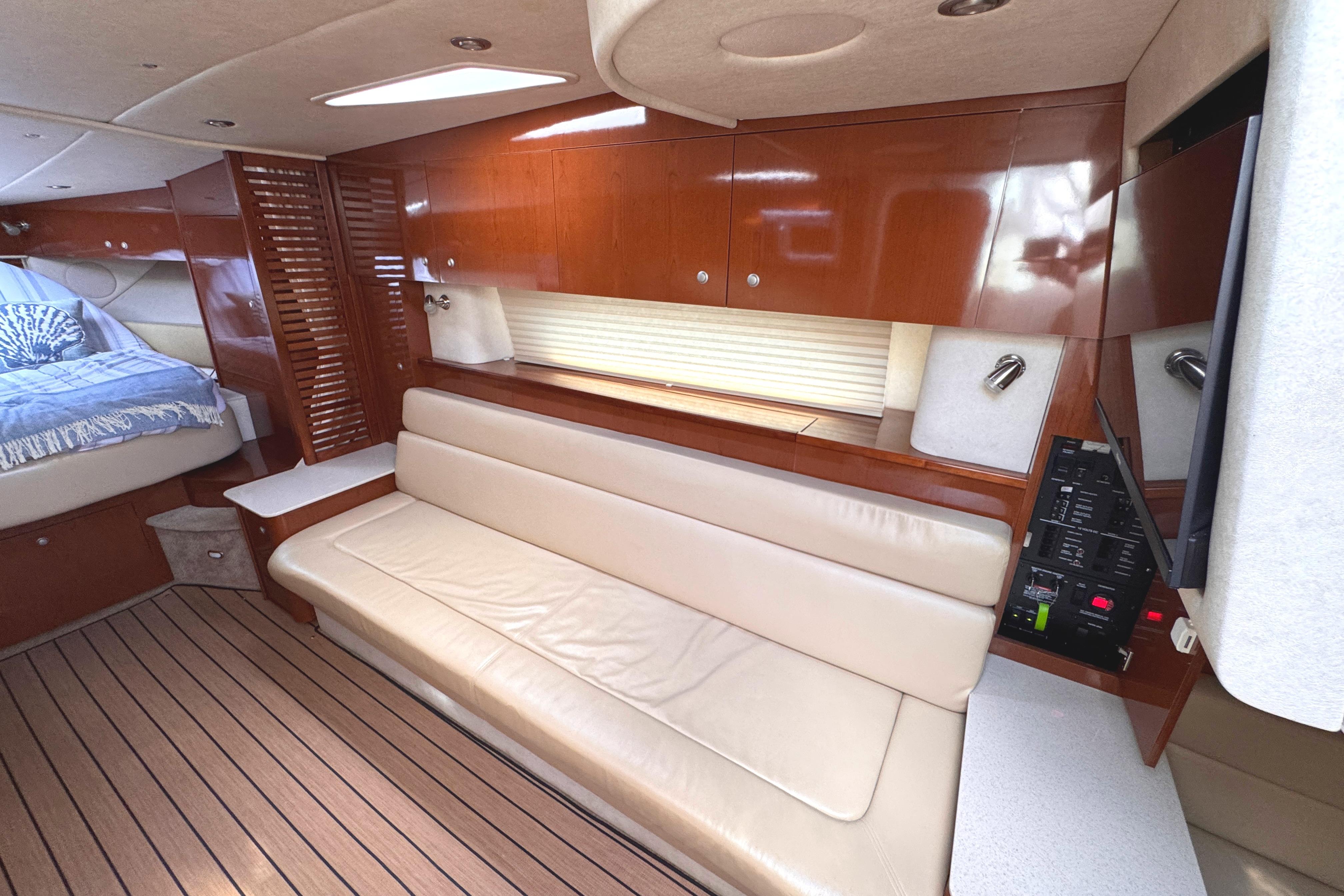 Interior of 2008 Sea Ray Sundancer 350 yacht with elegant wood finish and cozy seating.