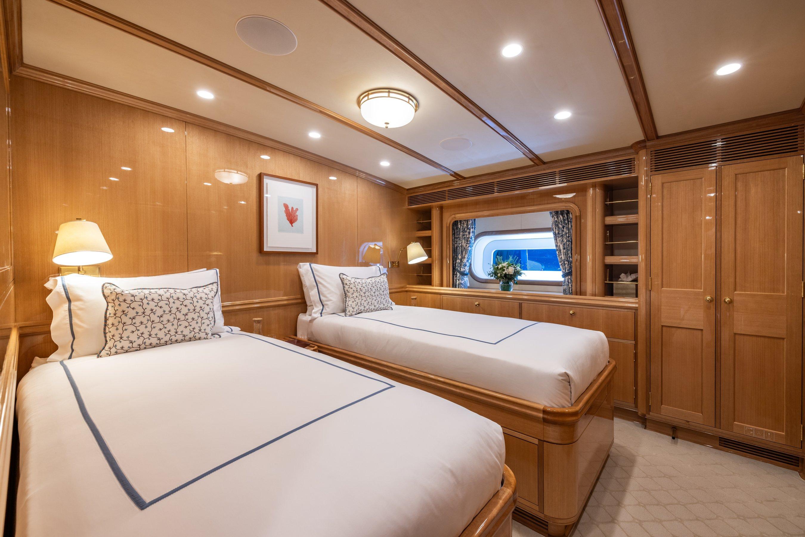 Luxurious twin cabin on 2023 Vitters Cruising Ketch yacht, featuring elegant wood finishes and cozy bedding.