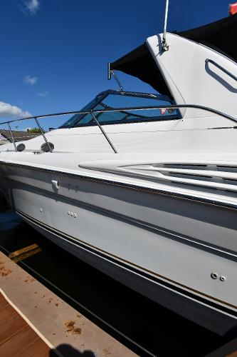 1997 Sea Ray 400 Sundancer yacht docked under clear blue sky.