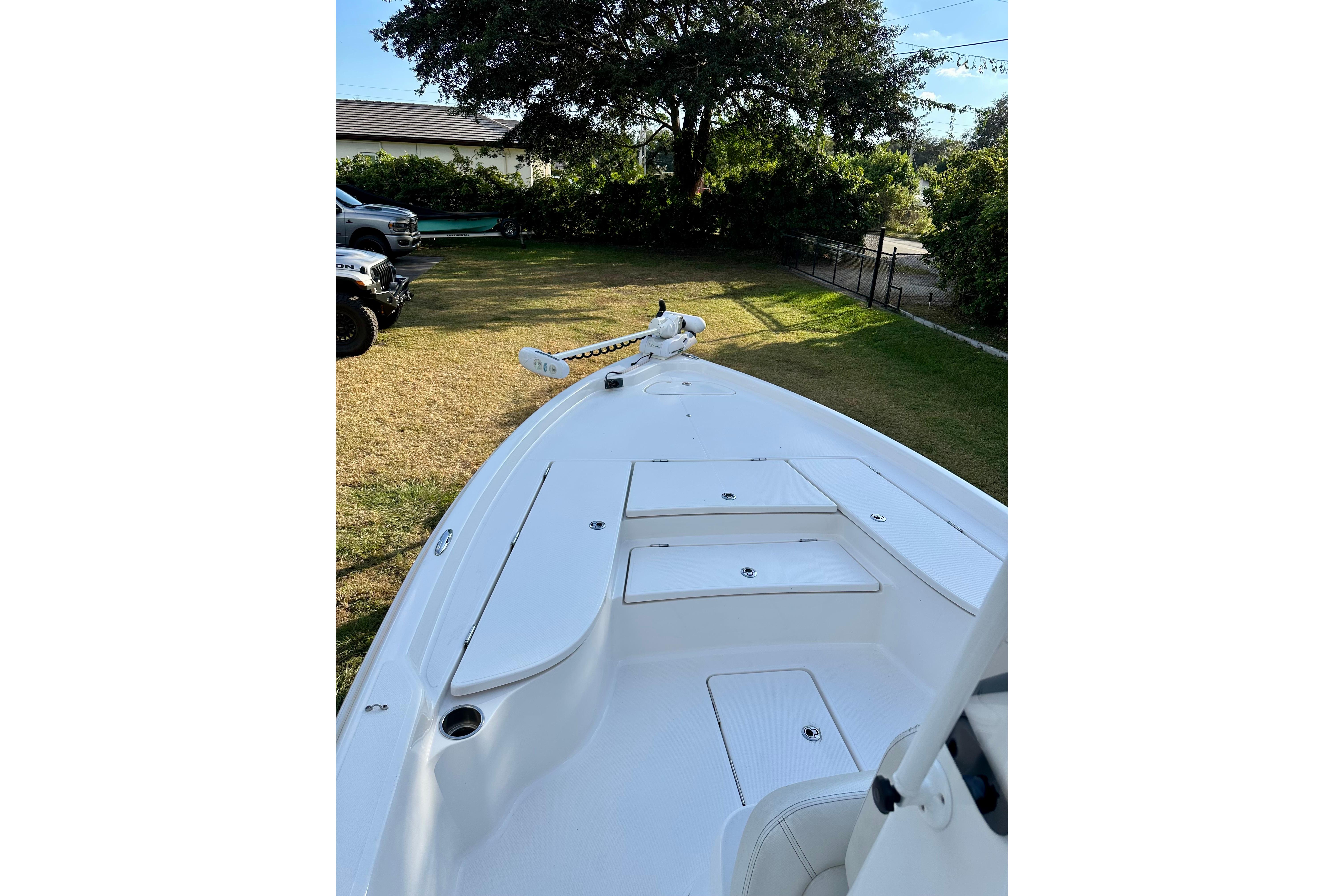 2017 Blue Wave 2400 PureBay boat on grass, showcasing sleek deck design.