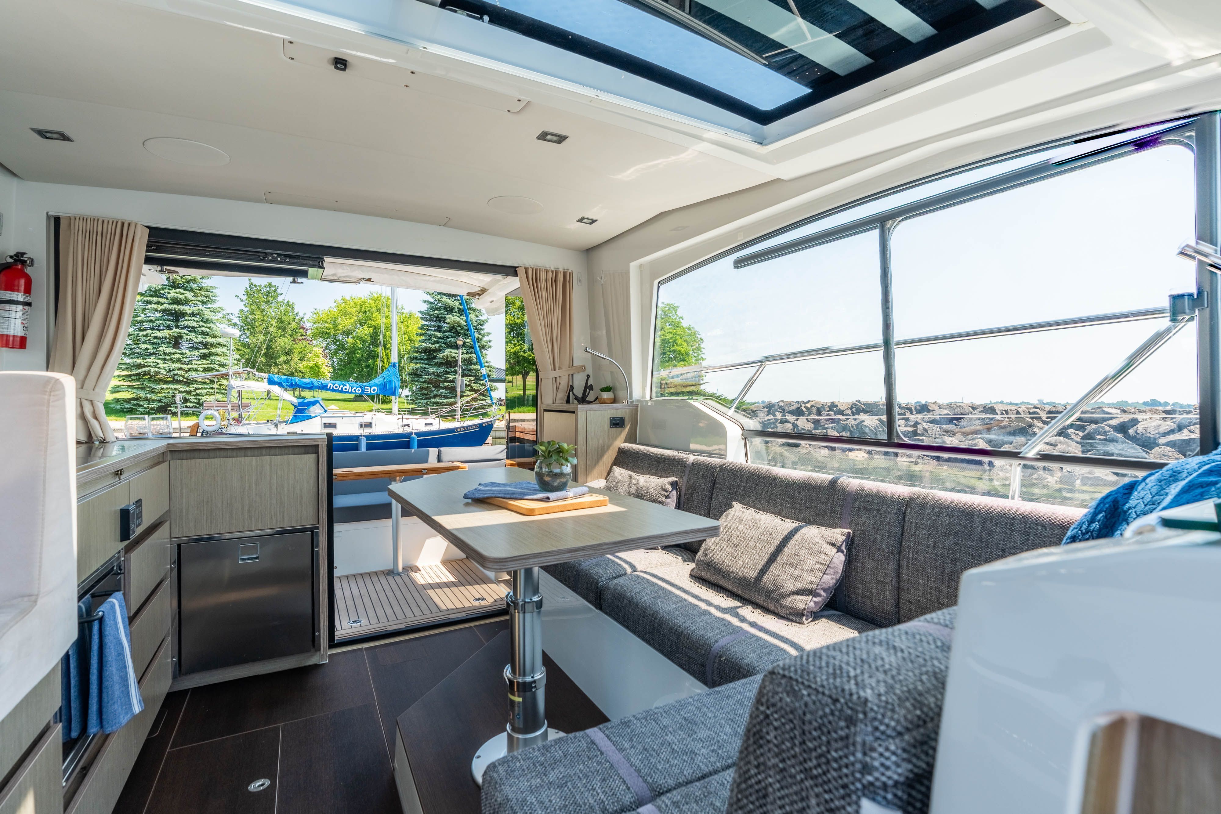 Interior of a 2023 Sealine C335V with modern design and panoramic windows.