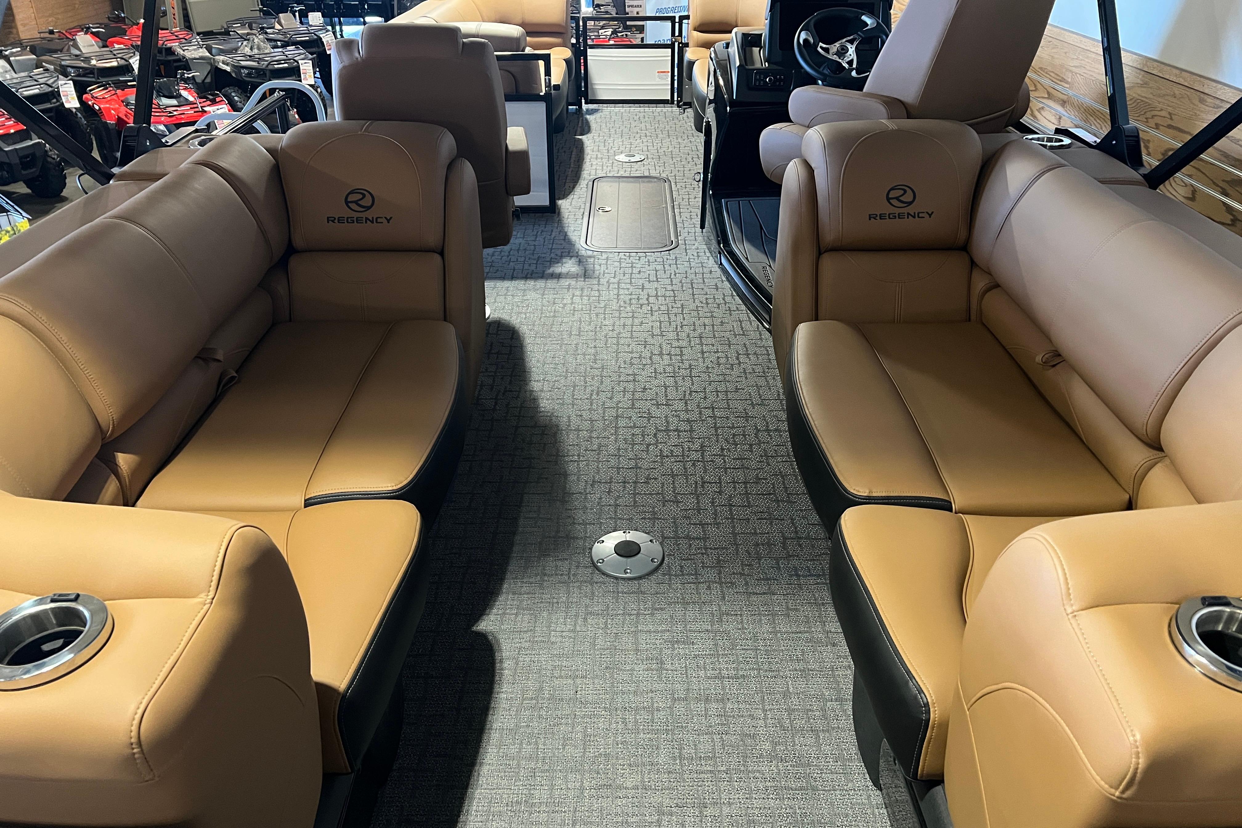 Luxurious interior of 2026 Regency 230 DL pontoon boat with tan seating and modern design.
