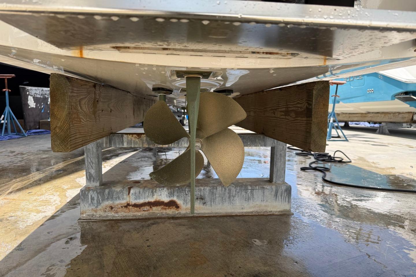2023 MasterCraft X24 boat propeller on a stand, viewed from below.
