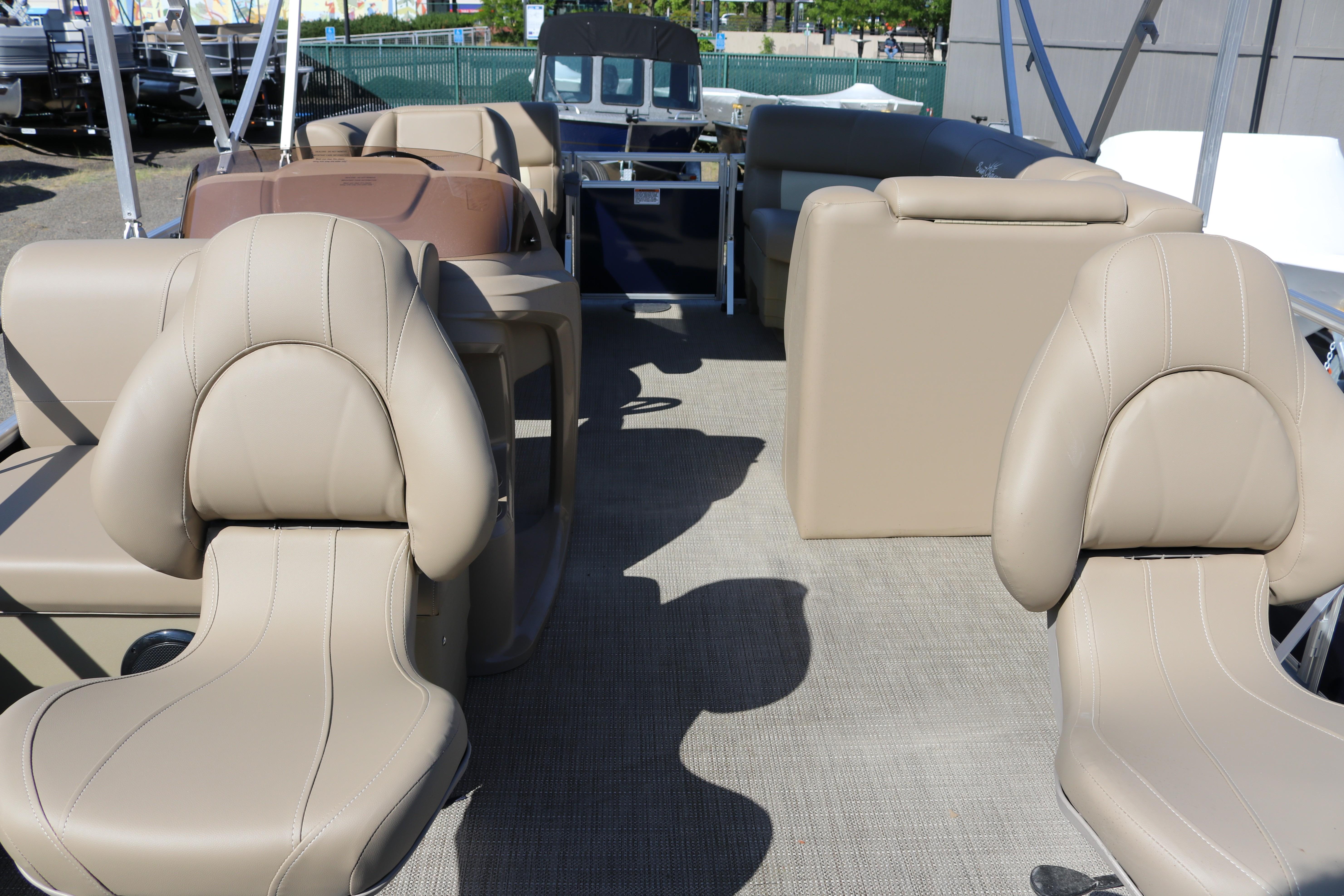 2025 Sun Chaser Vista Fish 18 interior with beige seating and spacious layout.