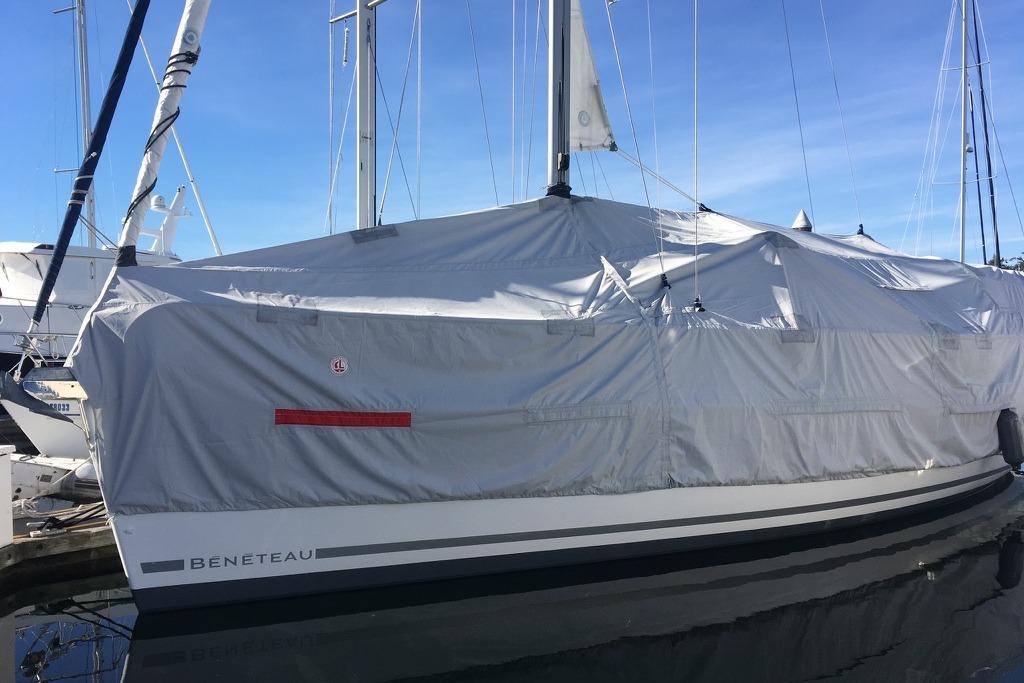 Covered 2010 Beneteau Oceanis 40 sailboat docked, showcasing protective tarp and sleek design.