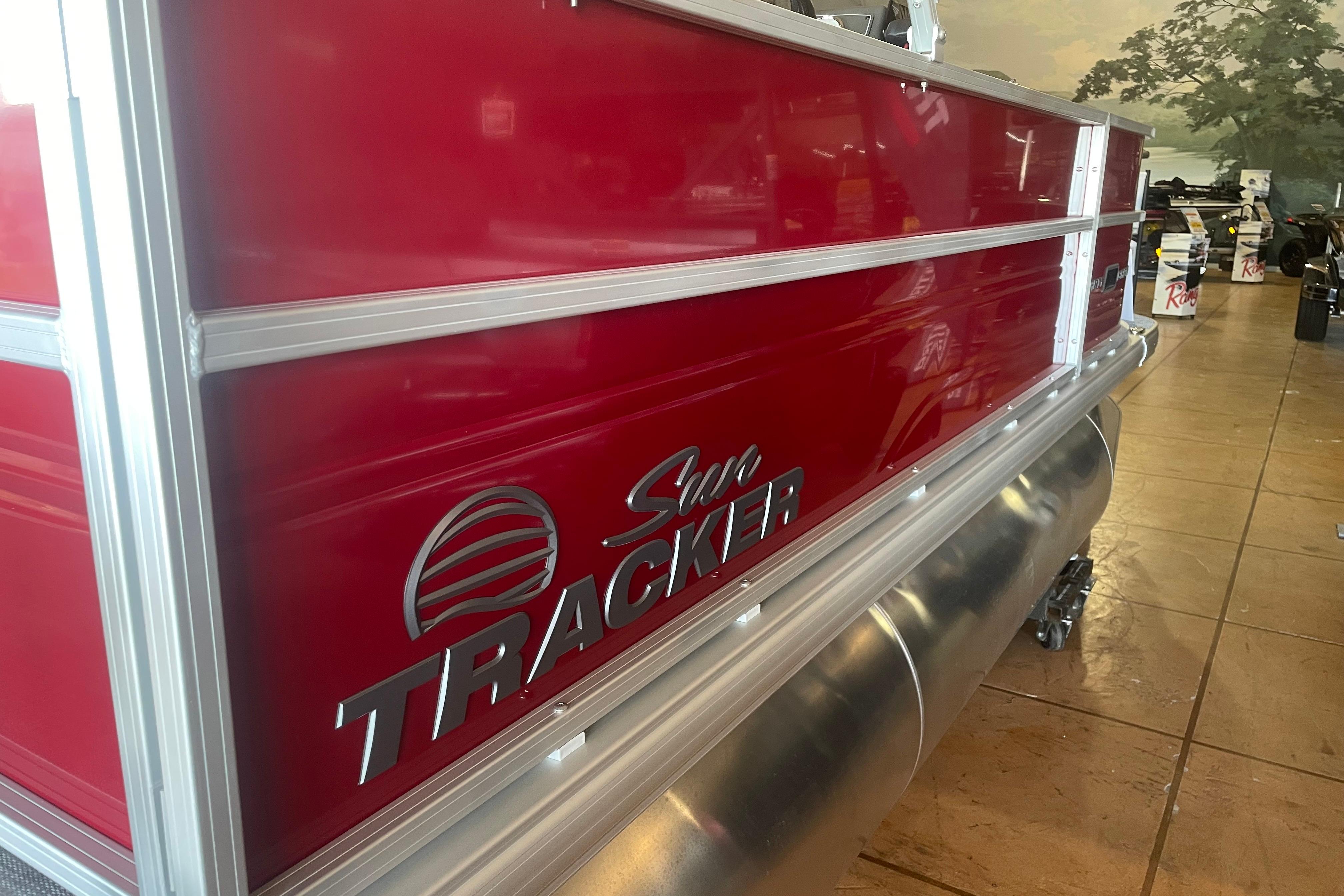 2026 Sun Tracker Party Barge 16 DLX pontoon boat with red exterior.