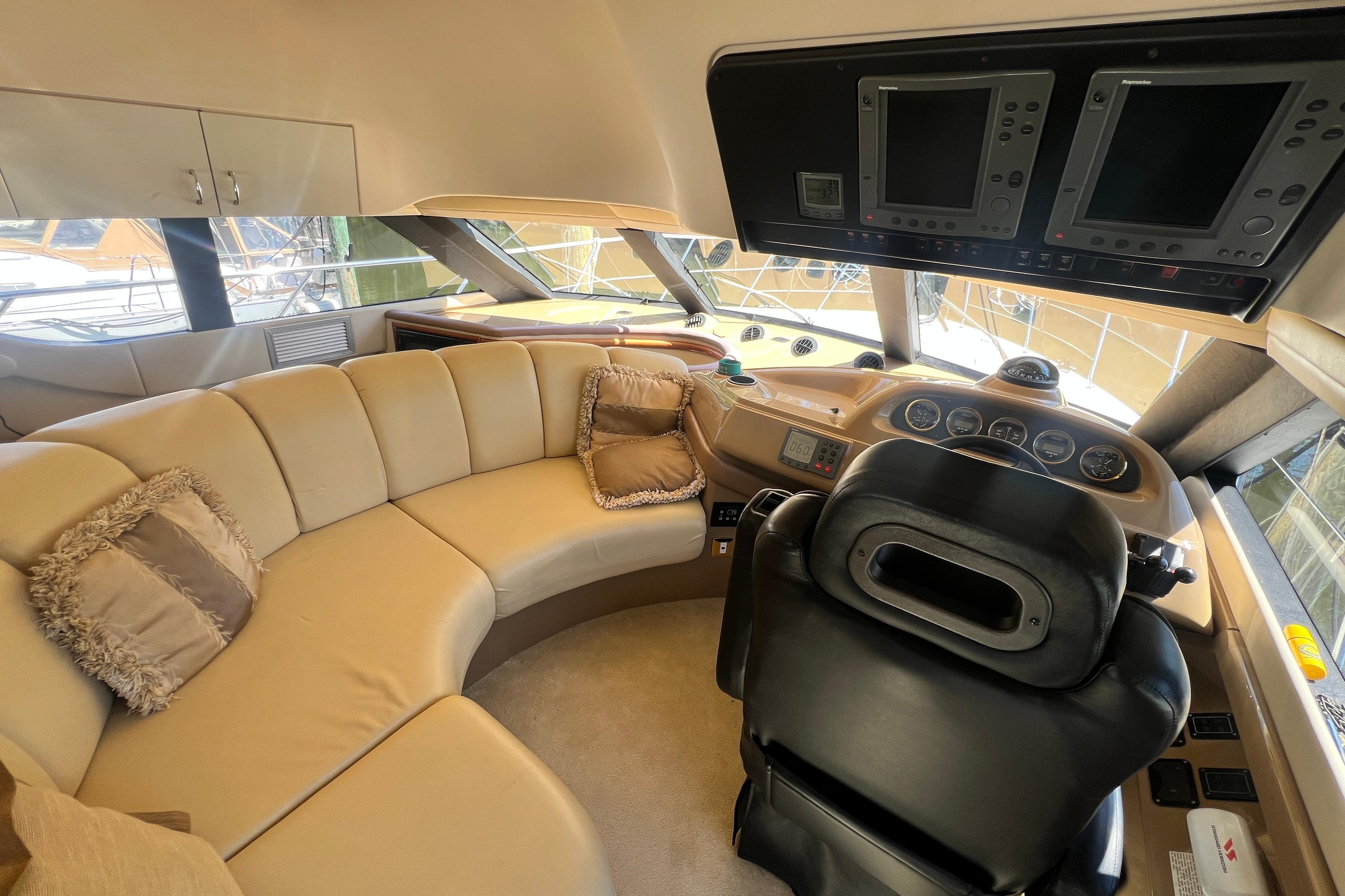 Luxurious interior of 2003 Carver 450 Voyager Pilothouse with plush seating and advanced navigation controls.