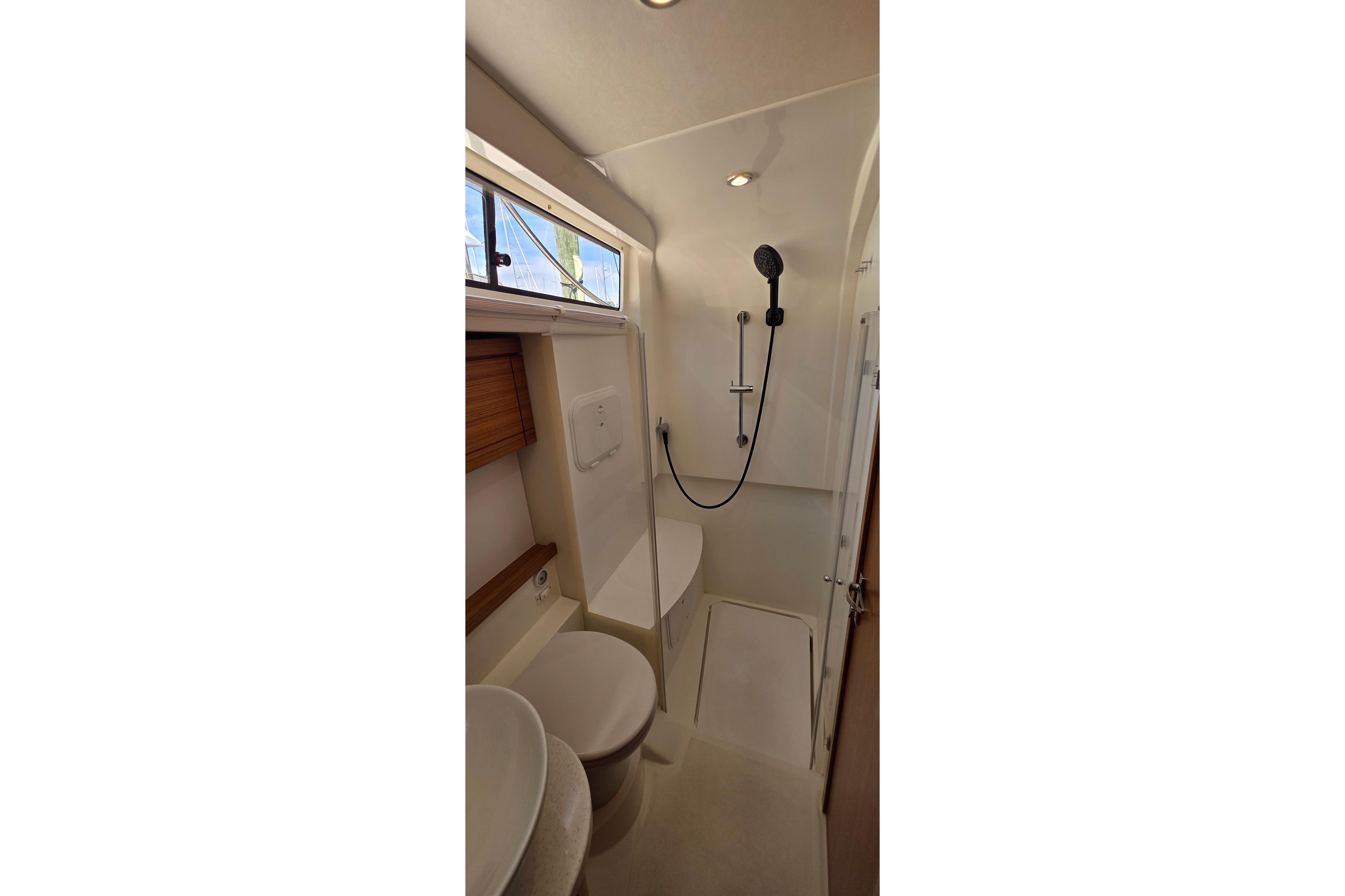 Modern bathroom interior of 2023 Greenline 40 yacht with shower and toilet.