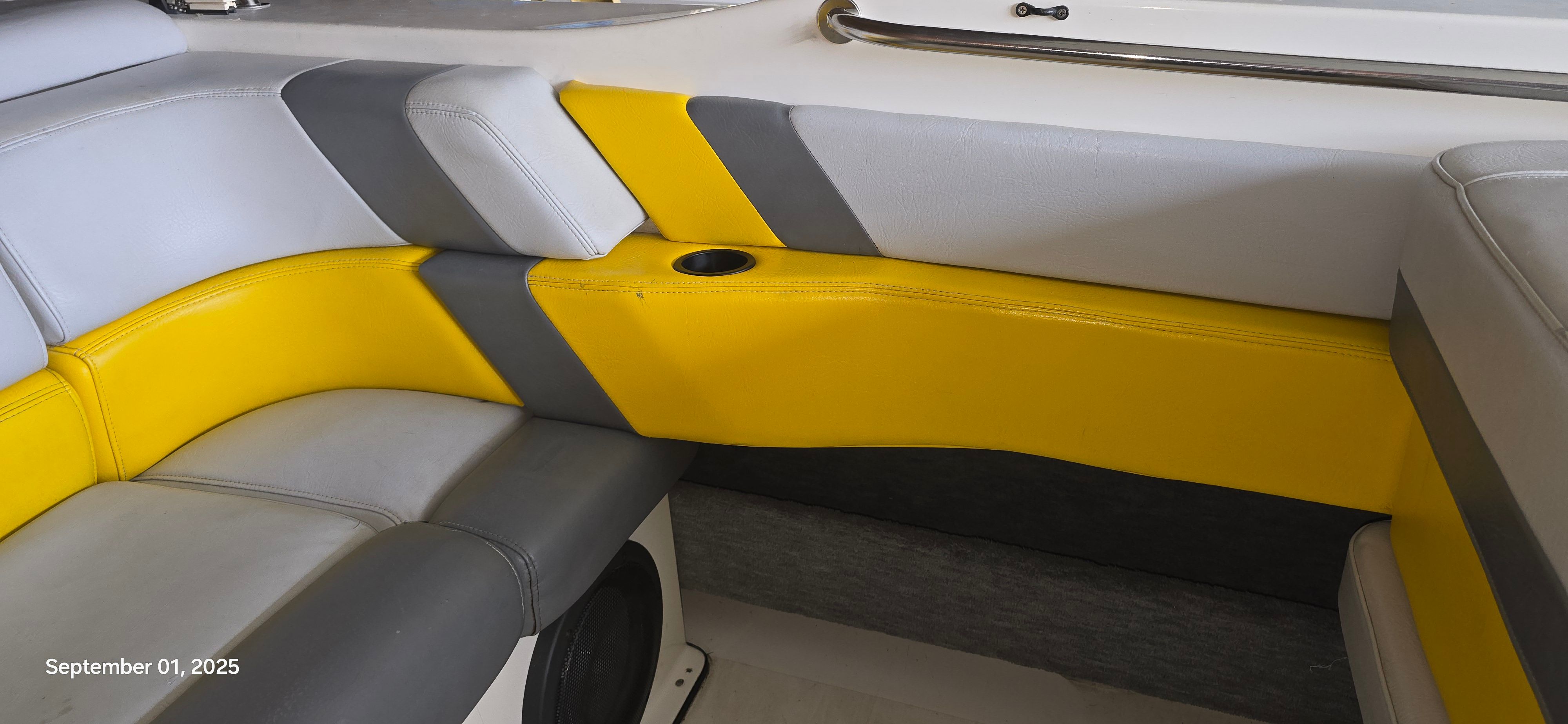 Interior of a 1989 Baja FORCE 235 with yellow and gray seating.