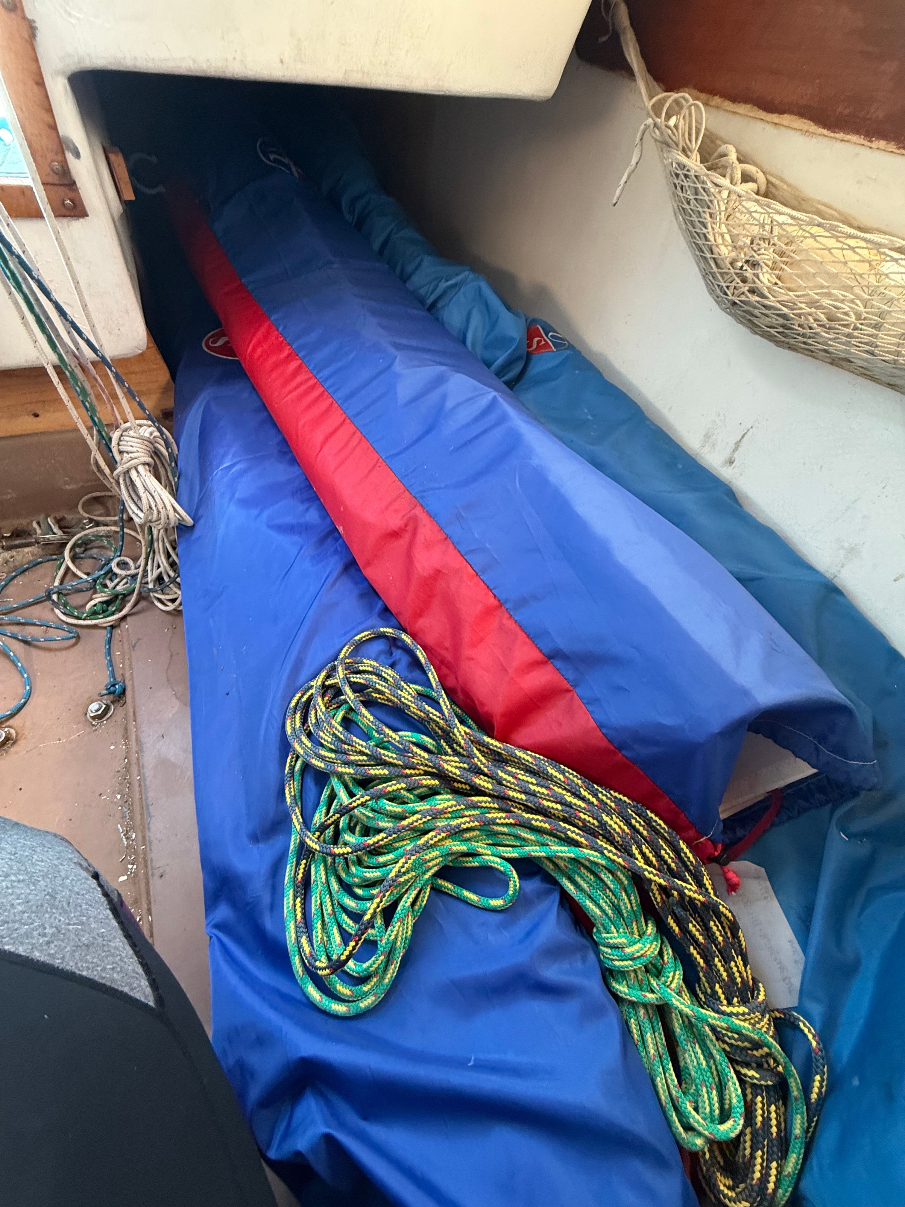 View inside a boat with ropes and sails.