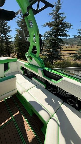 The image shows the interior of a 2018 Nautique Super Air Nautique G23 with green accents.