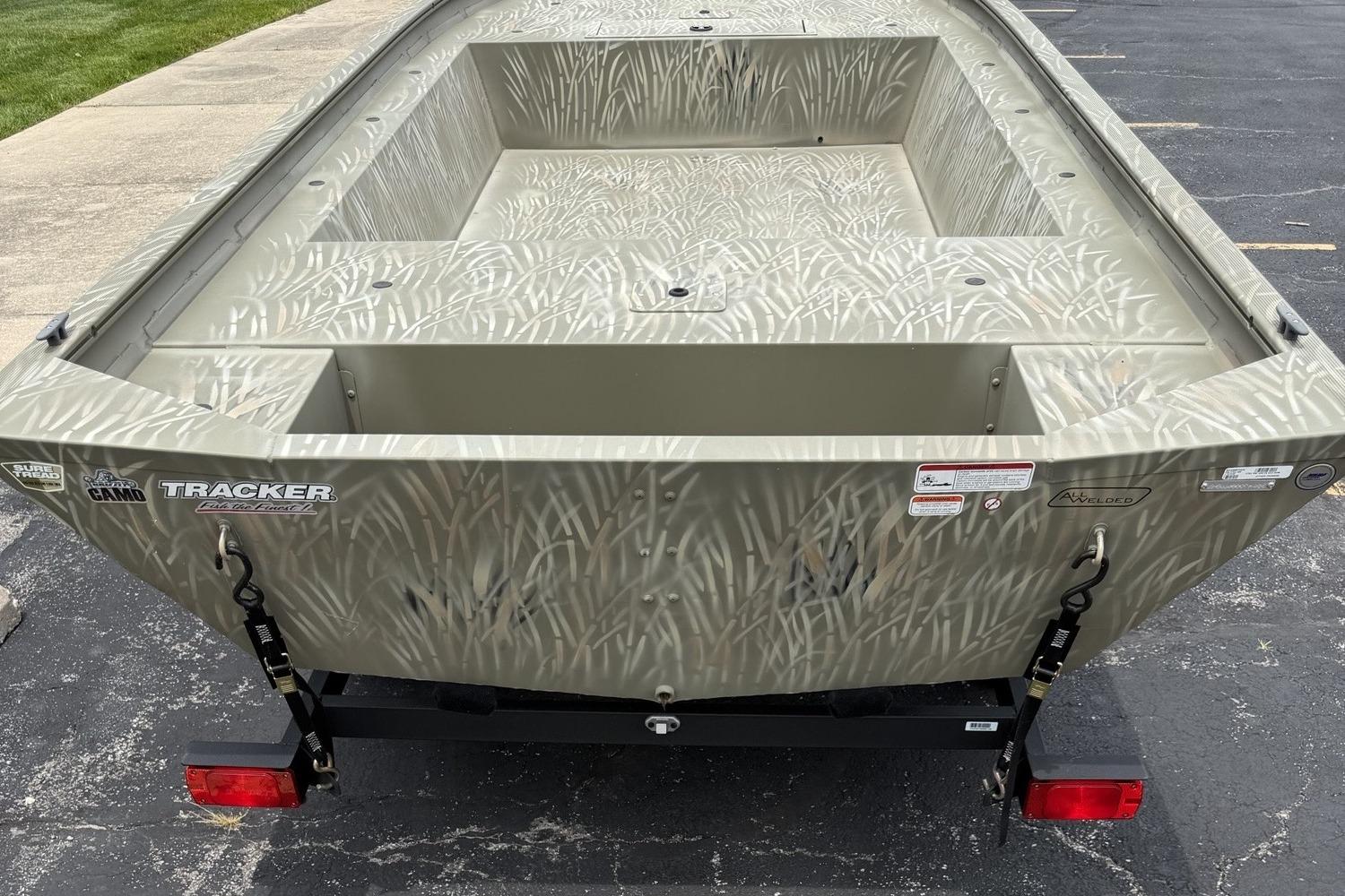2025 Tracker Grizzly 1754 Jon boat with camouflage design on a trailer.