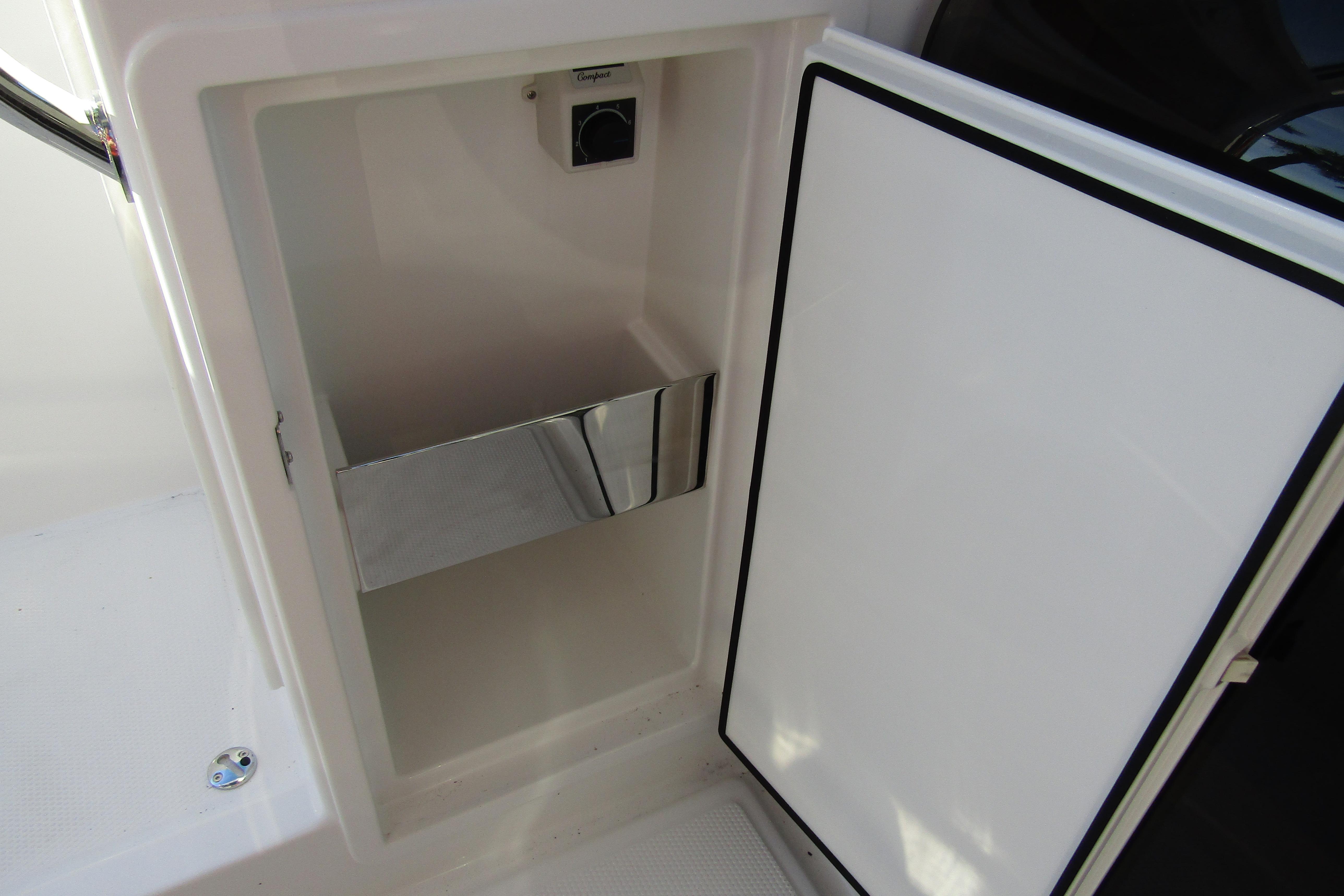 Open storage compartment on 2025 Nimbus Tender 9 boat, featuring a sleek interior design.