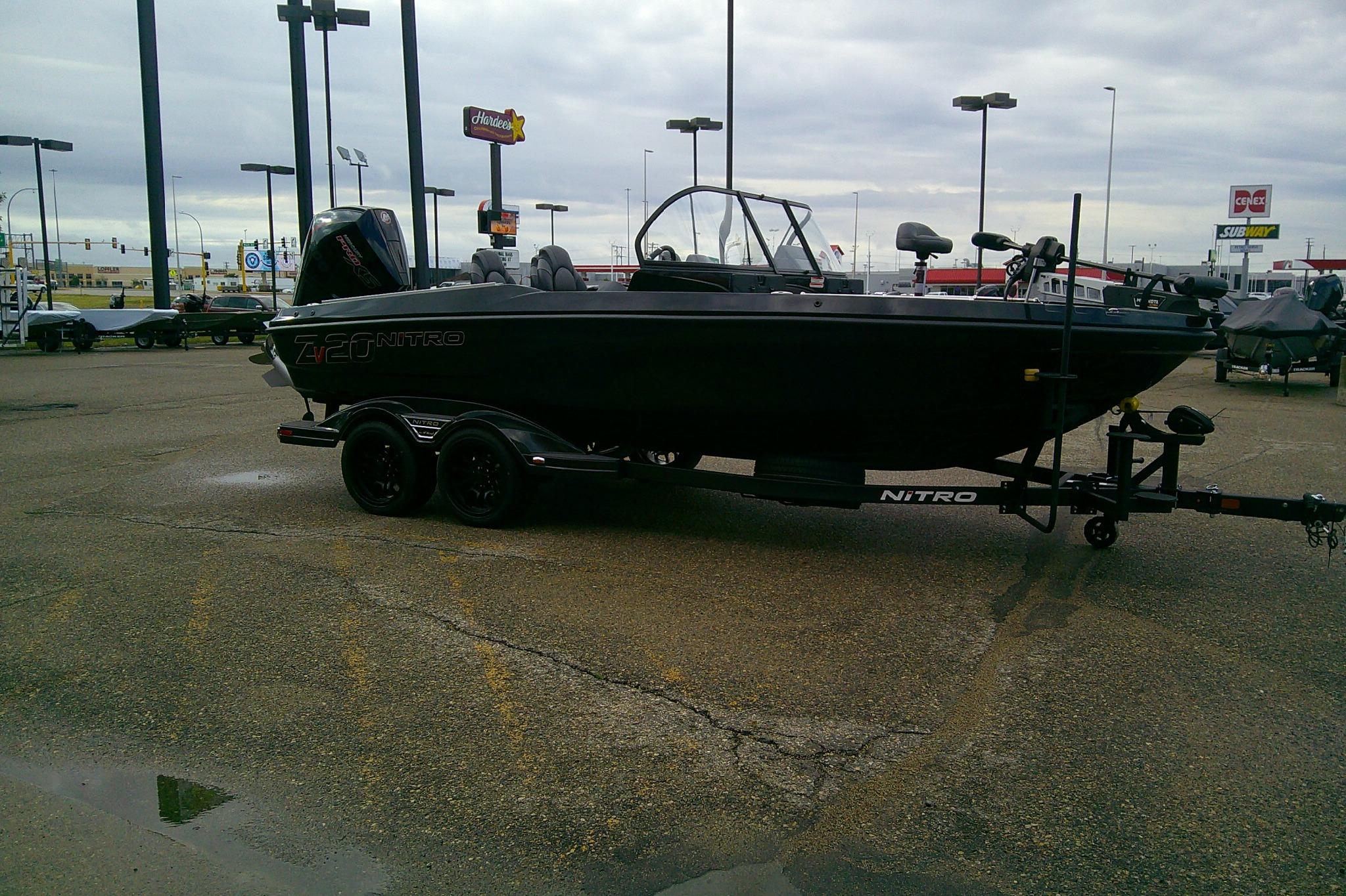 2026 Nitro ZV20 boat on trailer in parking lot, overcast sky.