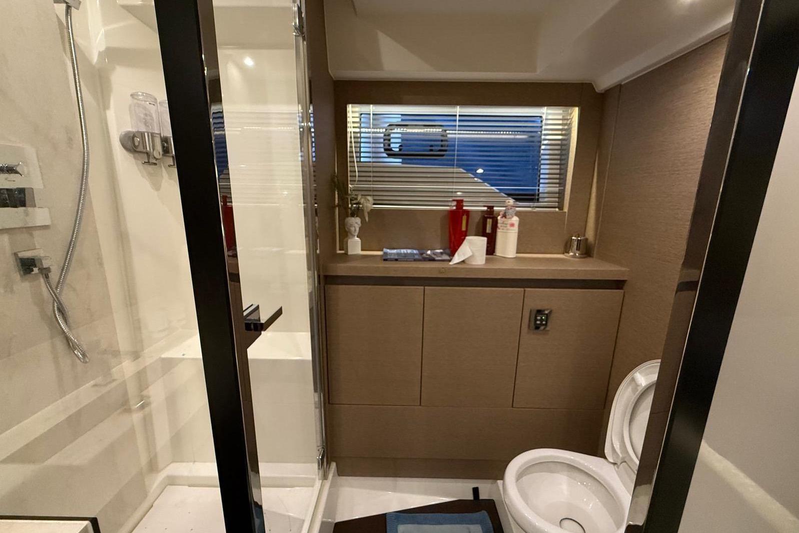 Luxurious bathroom in 2019 Prestiage 630 yacht, featuring modern fixtures and elegant design.