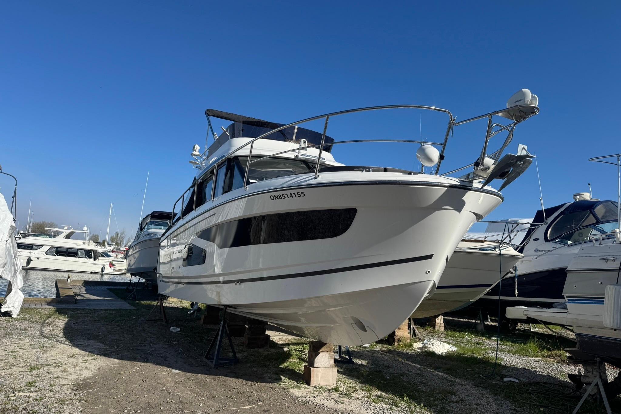 2022 Jeanneau NC 1095 Fly yacht on dry dock under clear blue sky.