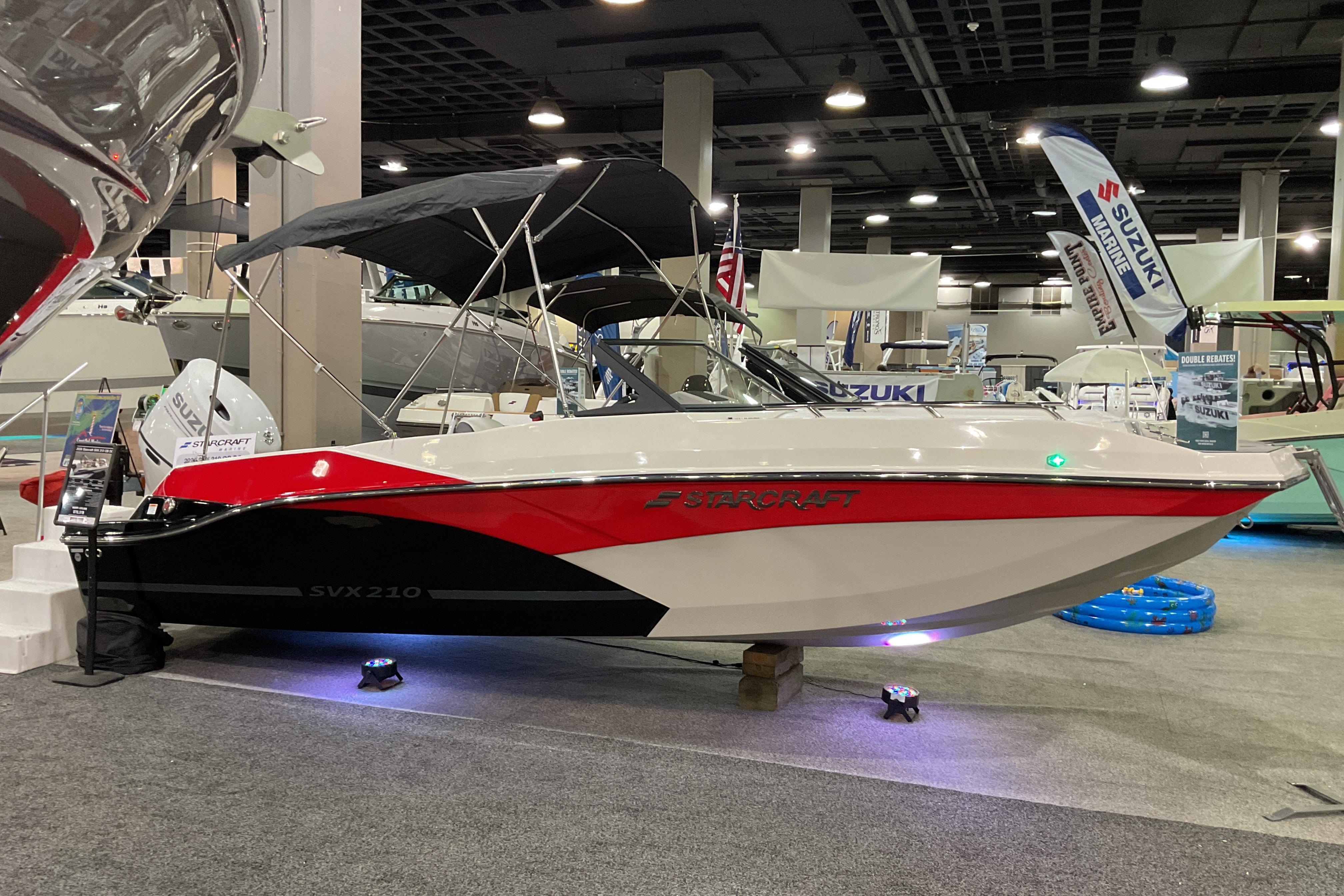 2026 Starcraft SVX 210 DC OB boat displayed at an indoor exhibition.