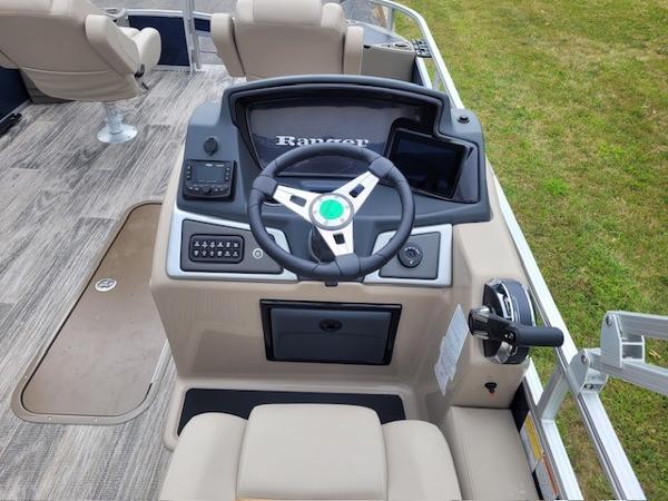 2024 Ranger Reata 223F boat helm with steering wheel and control panel.