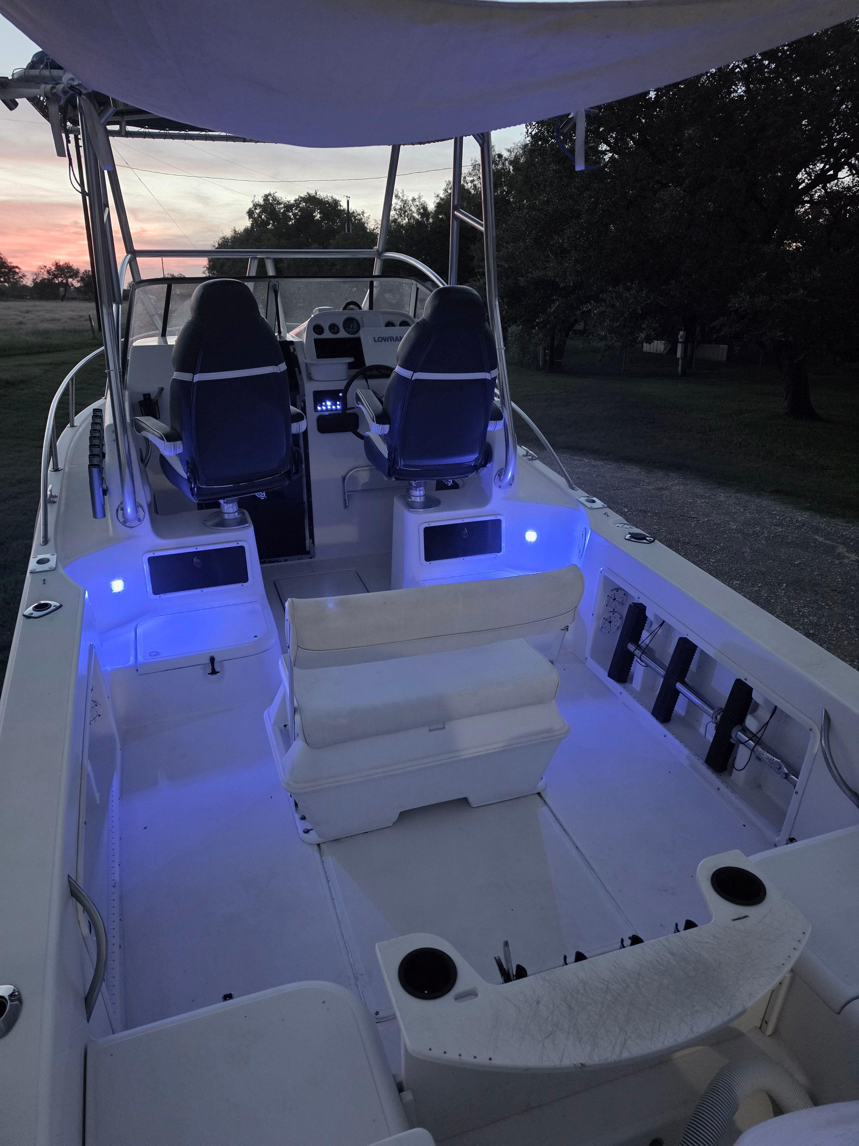 The image shows the cockpit of a 1998 Hydra-Sports 2450 boat with blue lighting.