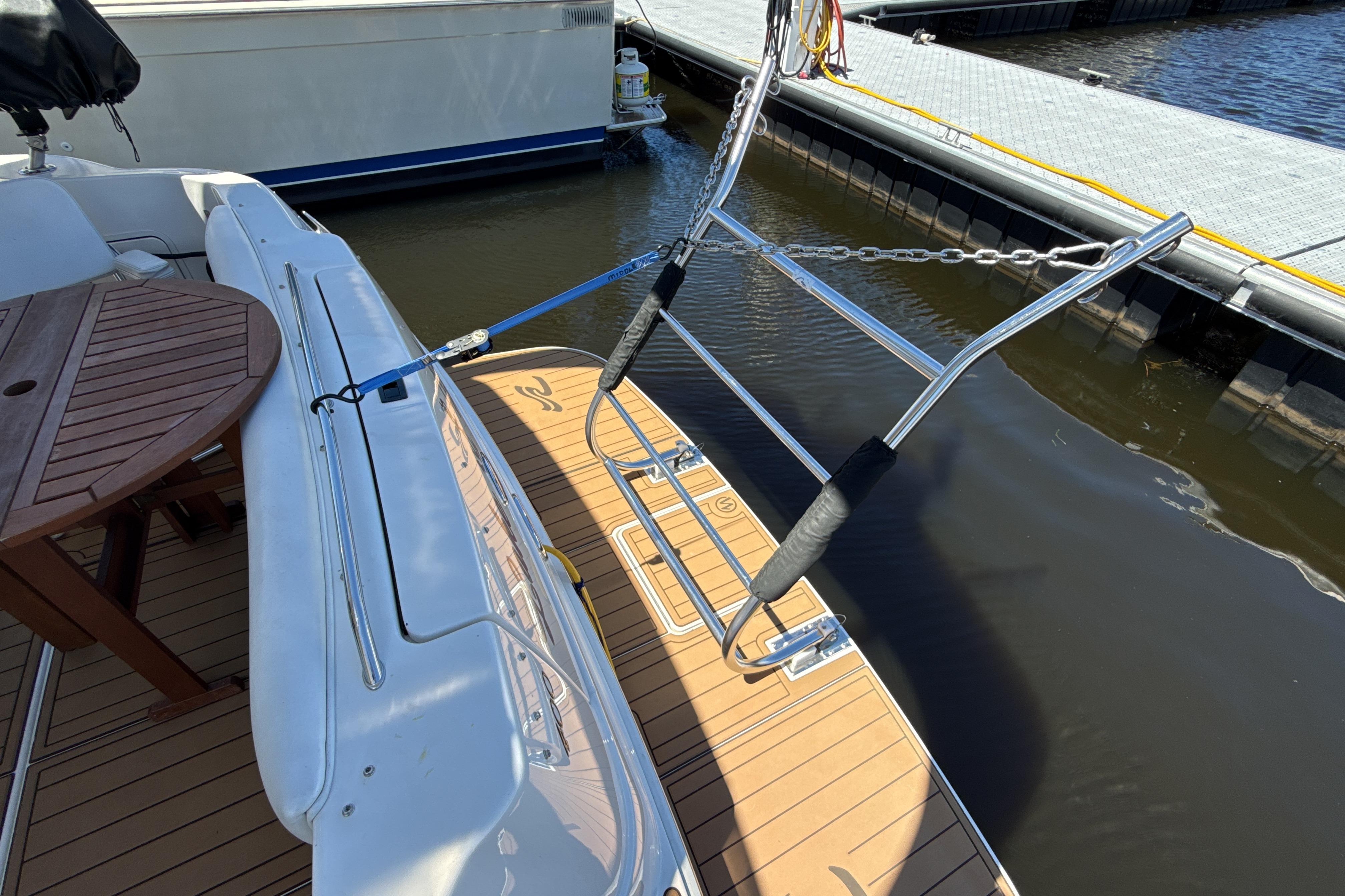 2001 Sea Ray 400 Sedan Bridge yacht with wooden deck and dock view.