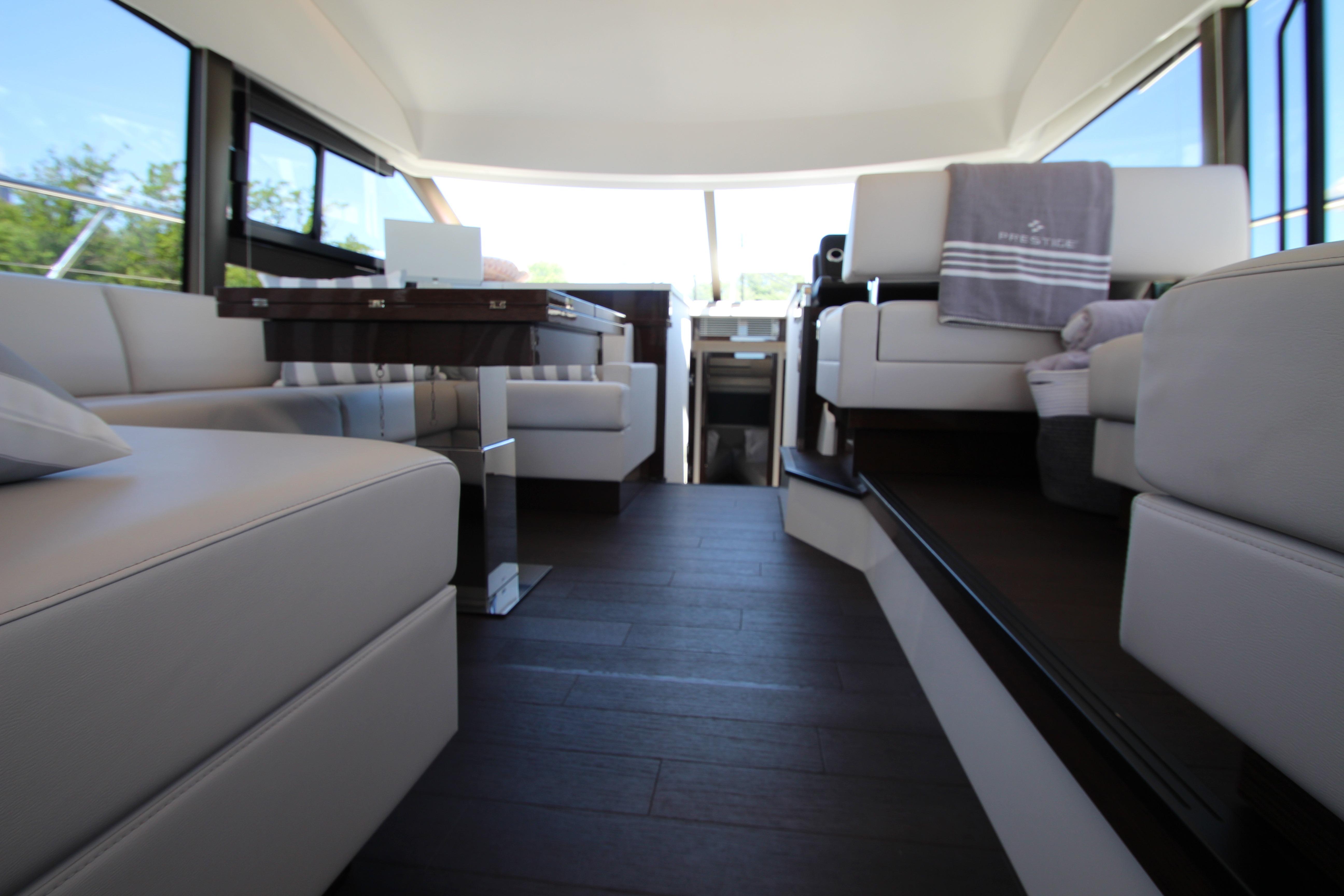 Luxurious interior of 2022 Prestige 520 yacht with elegant seating and modern design.