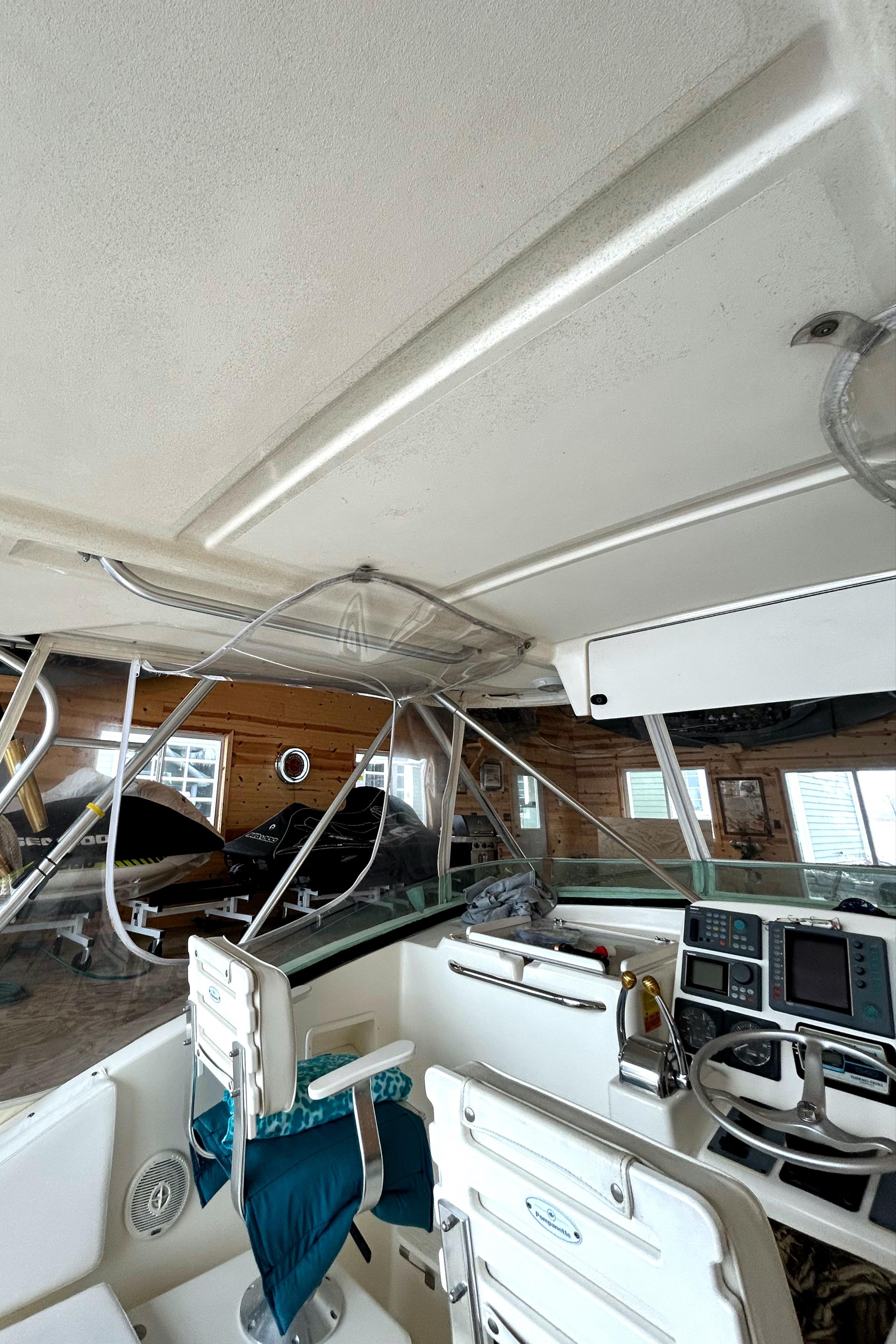 1998 Pursuit 3000 Offshore boat cockpit with helm, electronics, and seating.