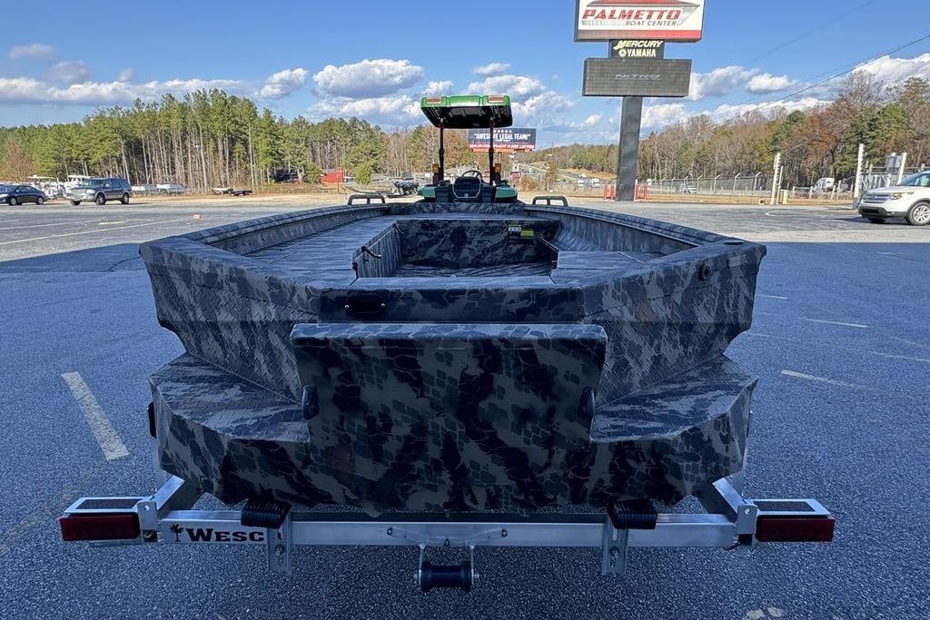2025 Havoc 1860 boat with camouflage design on a trailer in a parking lot.