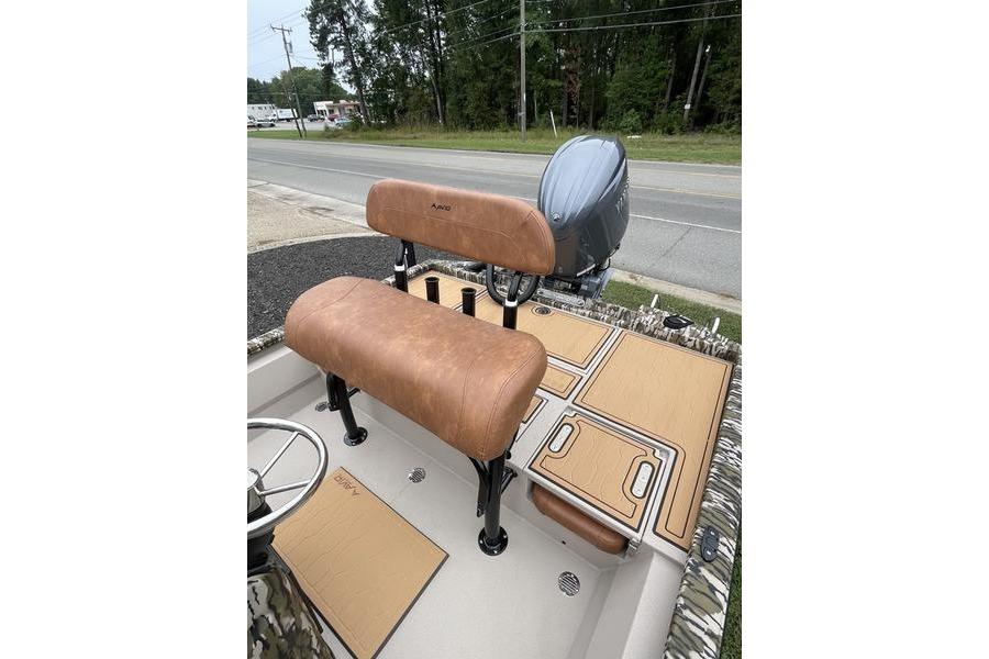 2026 Avid 21 FSX boat interior with tan seating and deck, parked roadside.