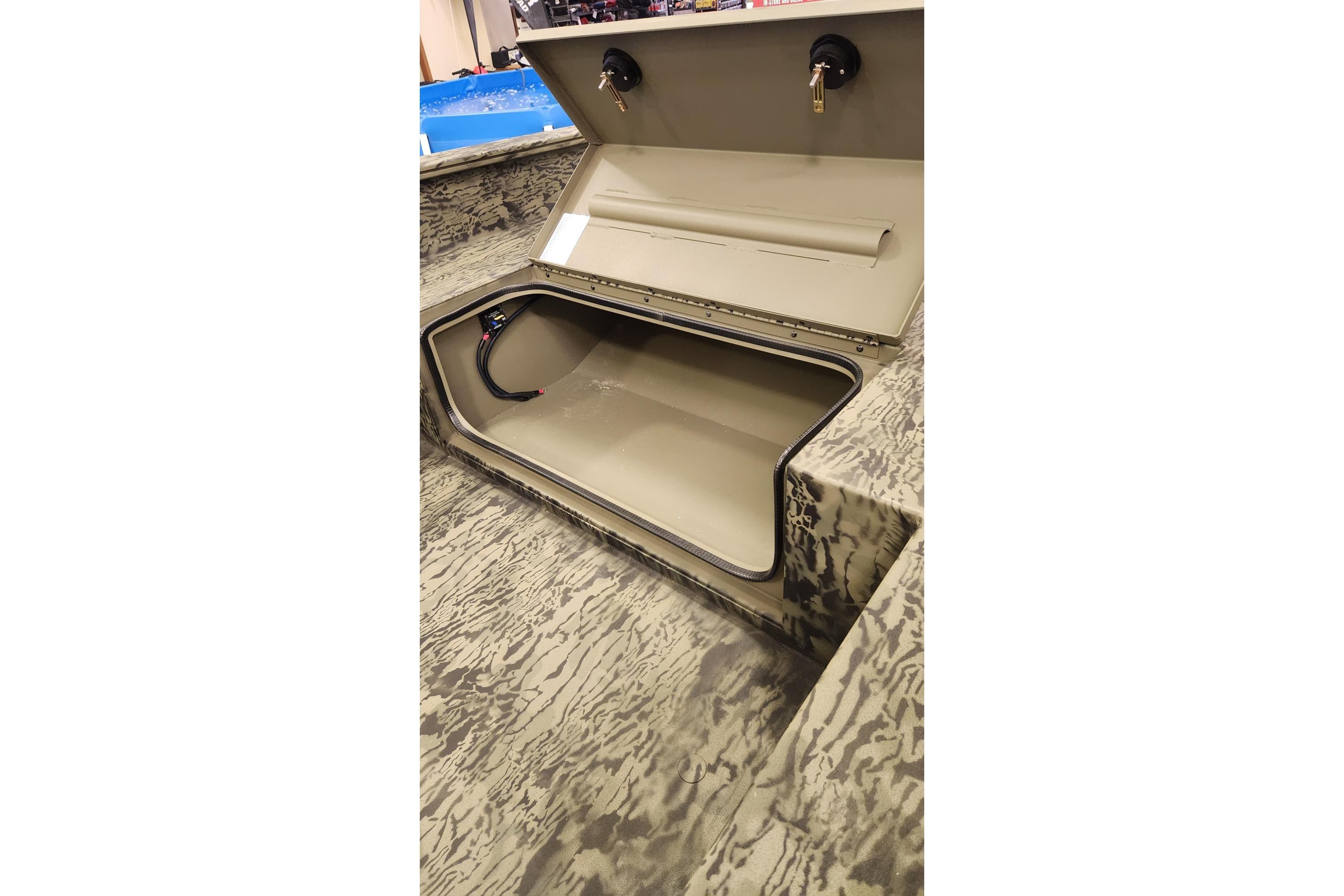 2025 Tracker Grizzly 1650 T Prairie Wings Edition storage compartment, open lid, camouflage interior.