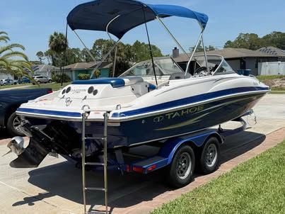 2011 Tahoe 216 WT boat parked outdoors on trailer.