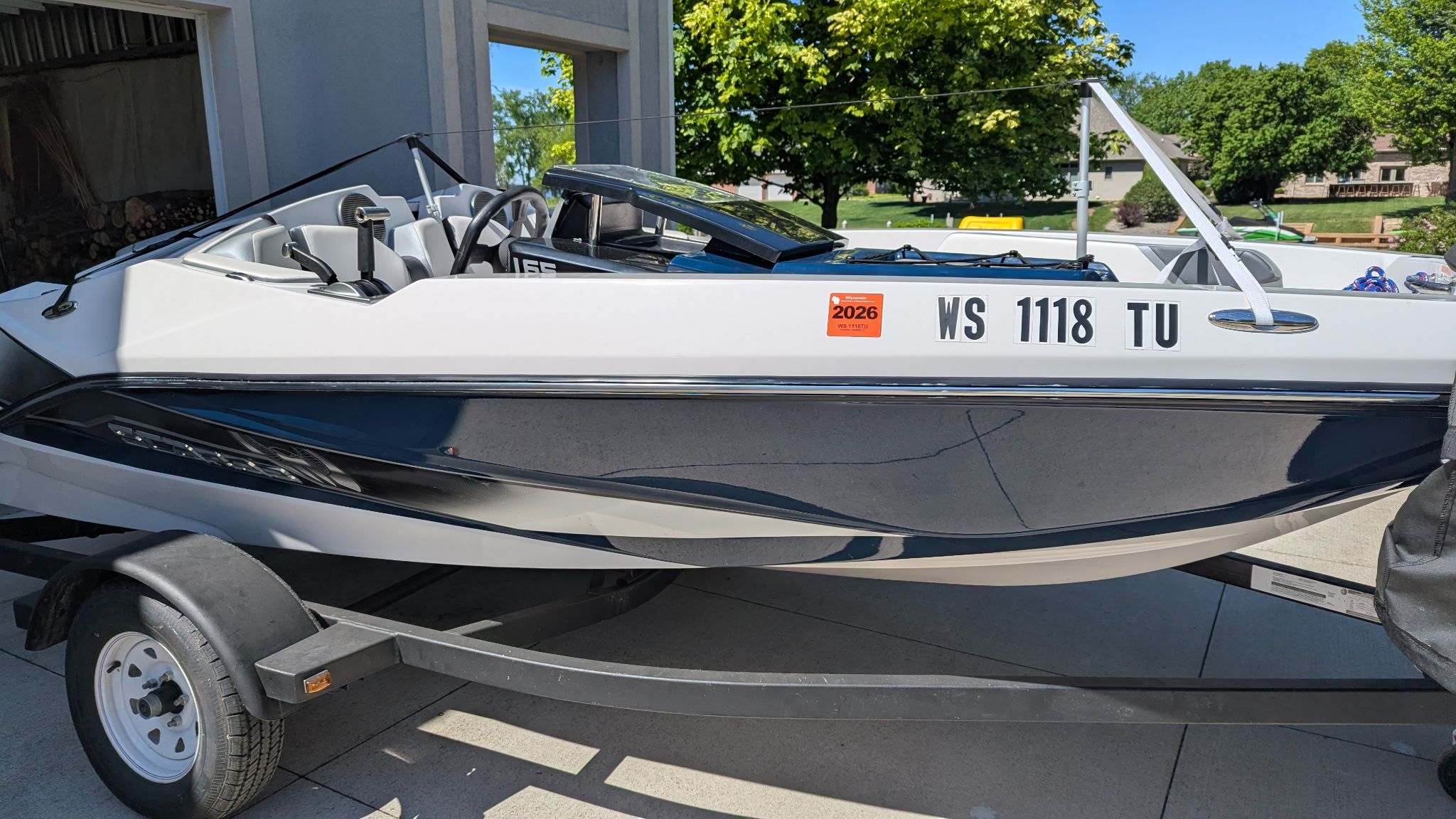 2017 Scarab 165 H.O. boat on trailer, side view.