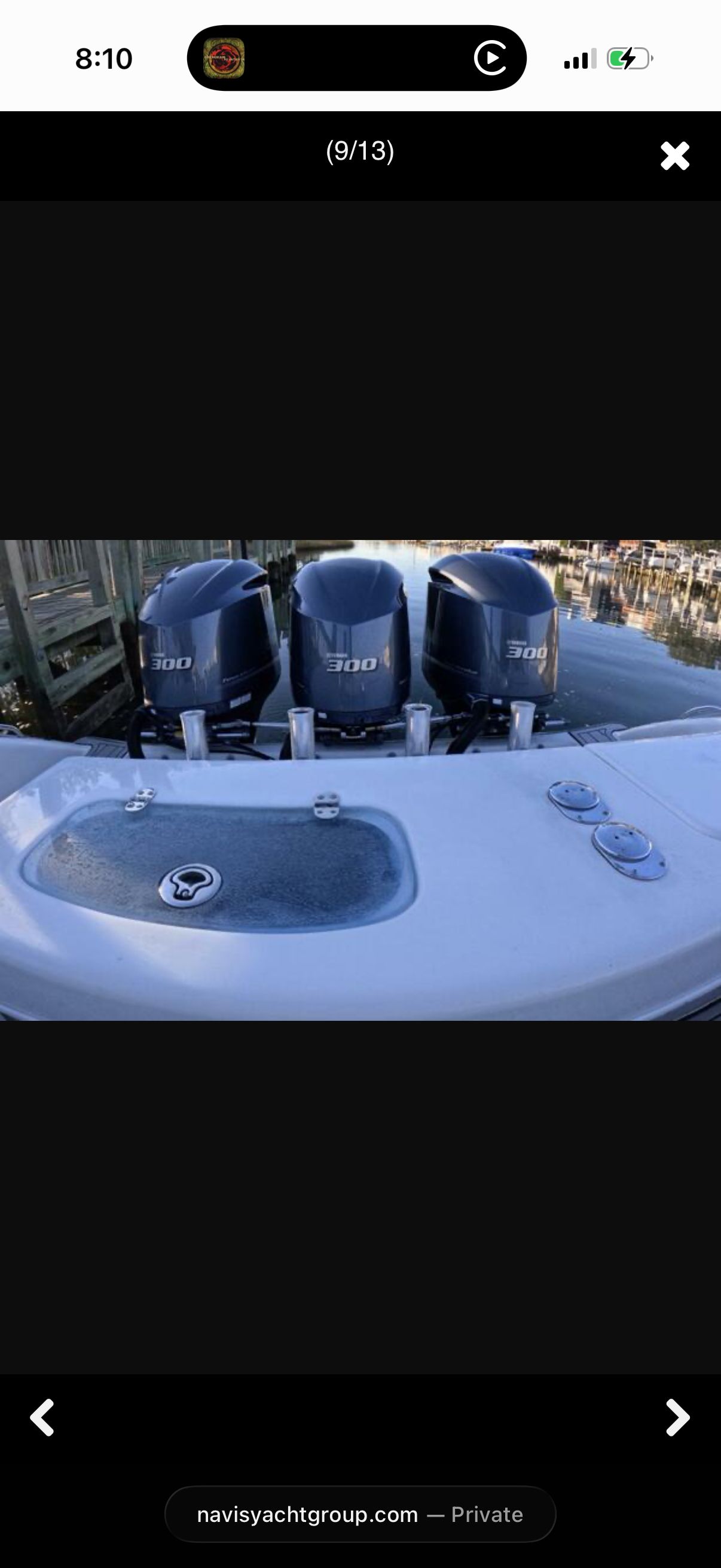 Three outboard motors on a boat, with a sink and controls in the foreground.