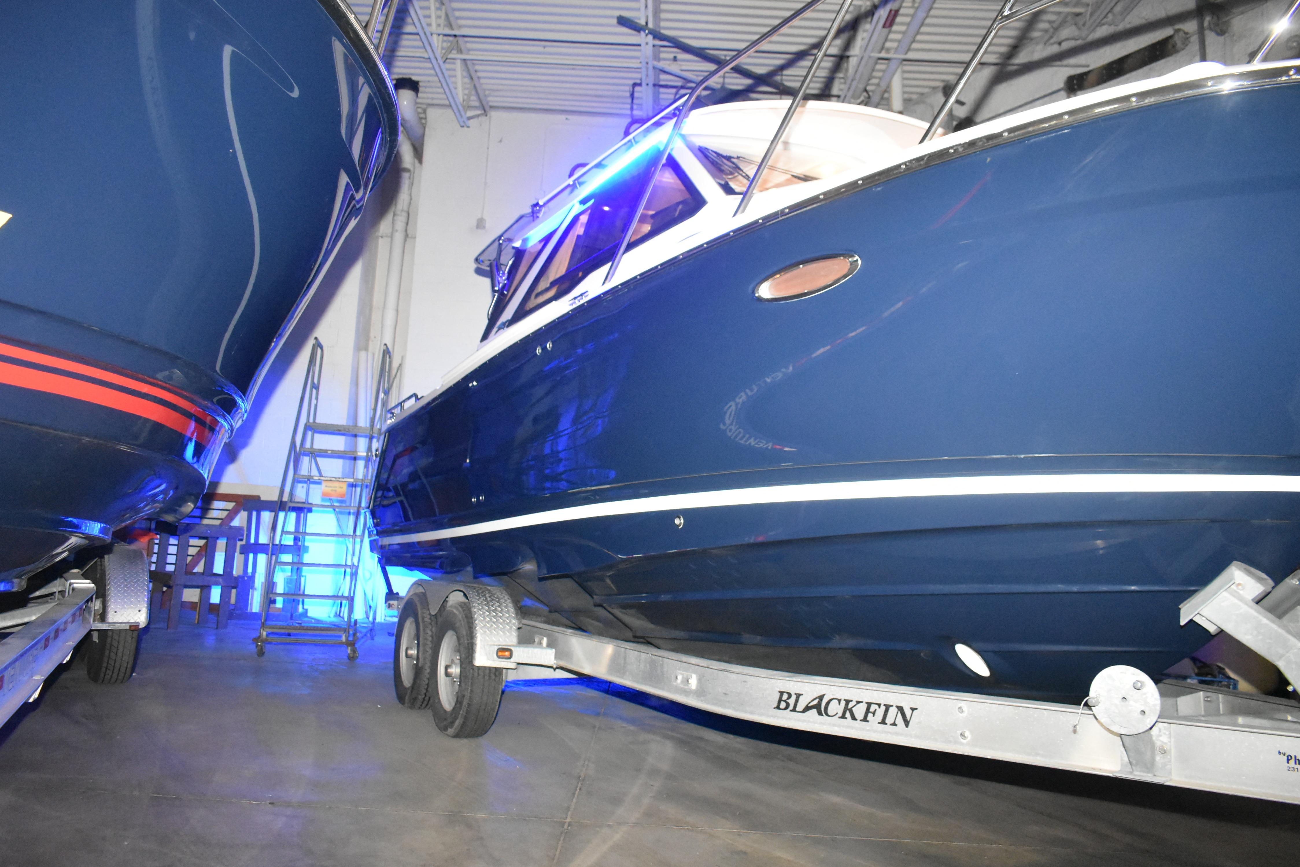 2026 Cutwater C-248 Coupe boat on trailer in indoor storage facility.
