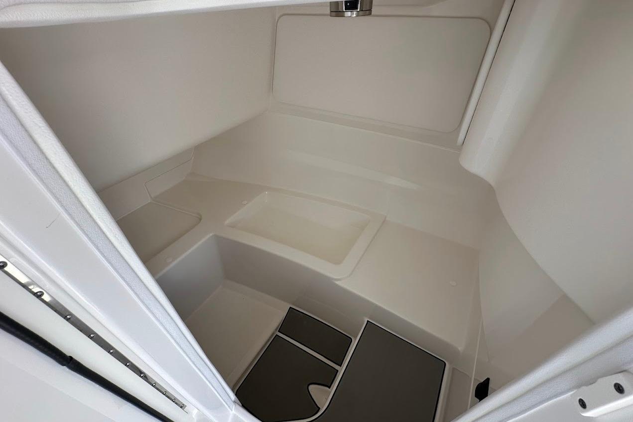 Interior cabin of 2026 Sea Ray SDX 230 Surf boat, featuring sleek white design.