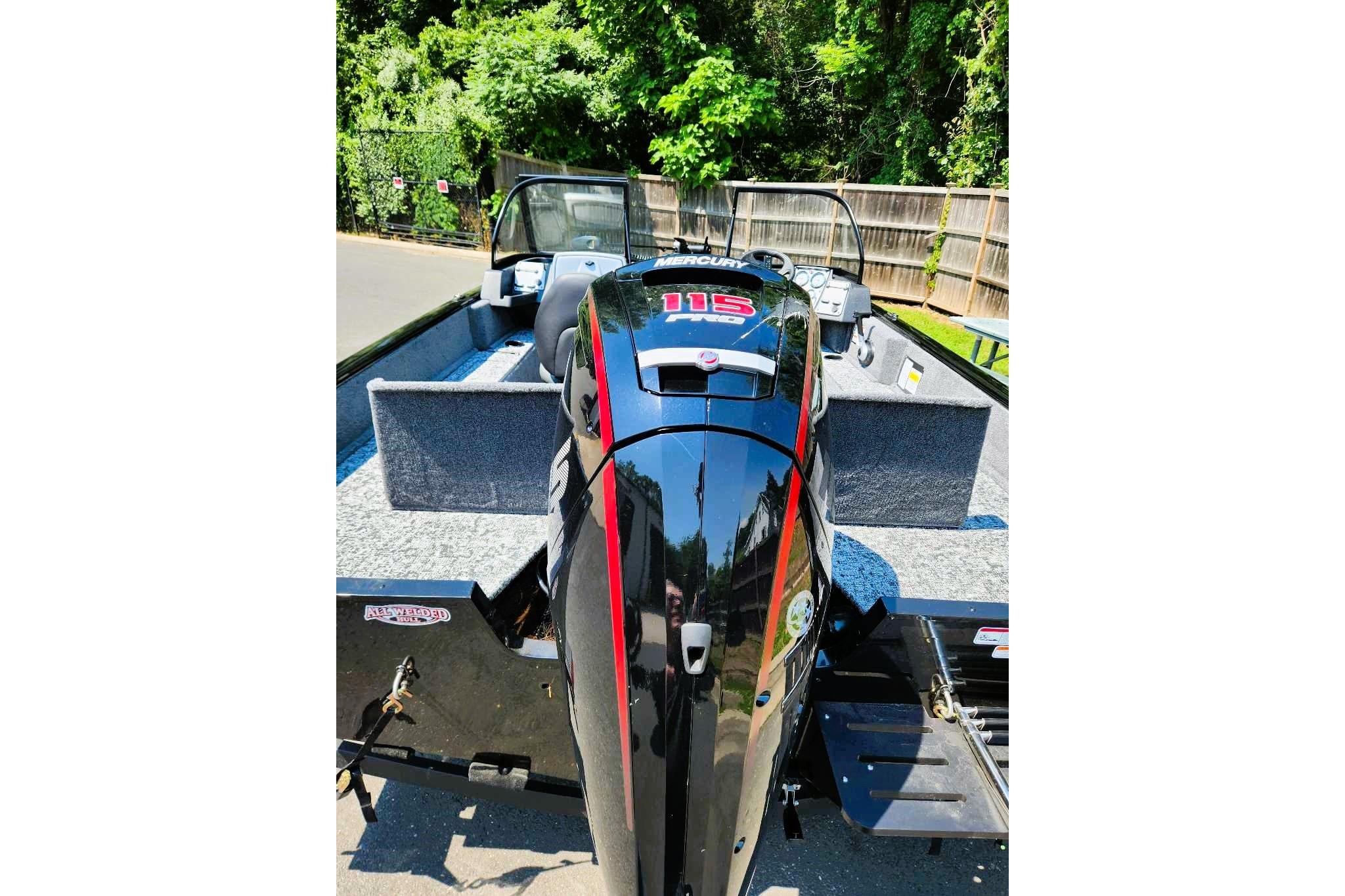 2026 Tracker Pro Guide V-175 Combo boat with Mercury 115 engine, parked outdoors.