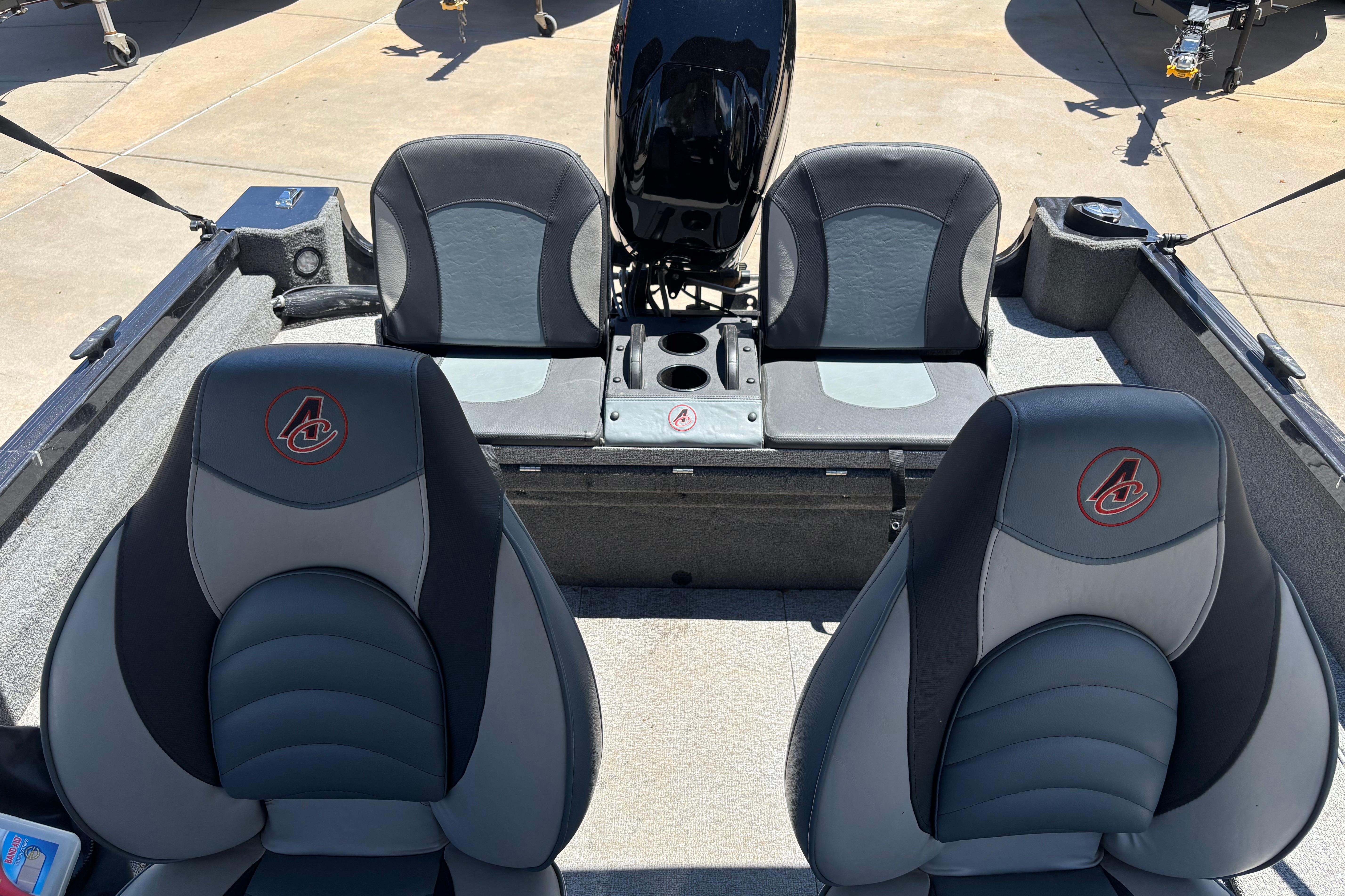 2021 Alumacraft Classic 165 boat interior with four cushioned seats and motor.